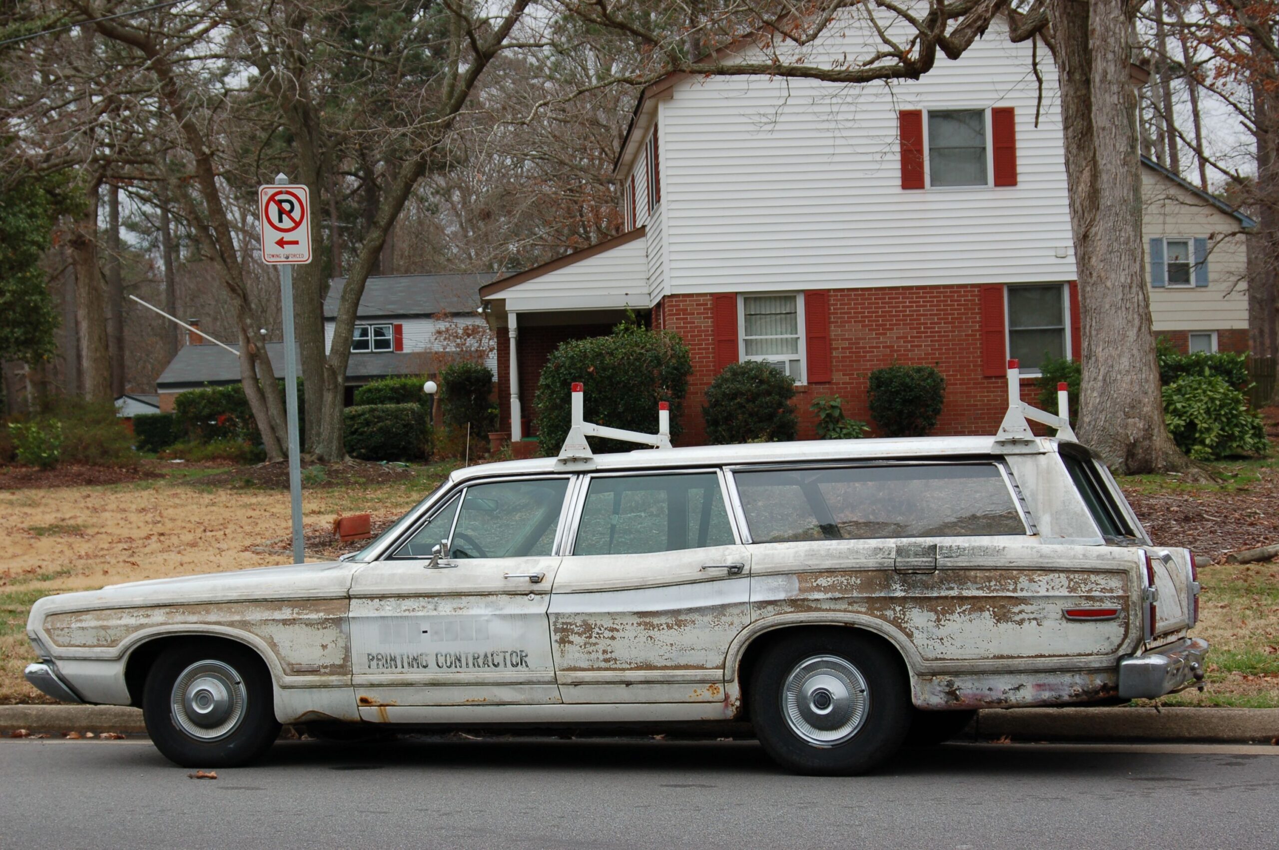 An old station wagon (still functional) sits on the side of the road. Only chipped paint flakes and rust hold it together but still the car does not die.
