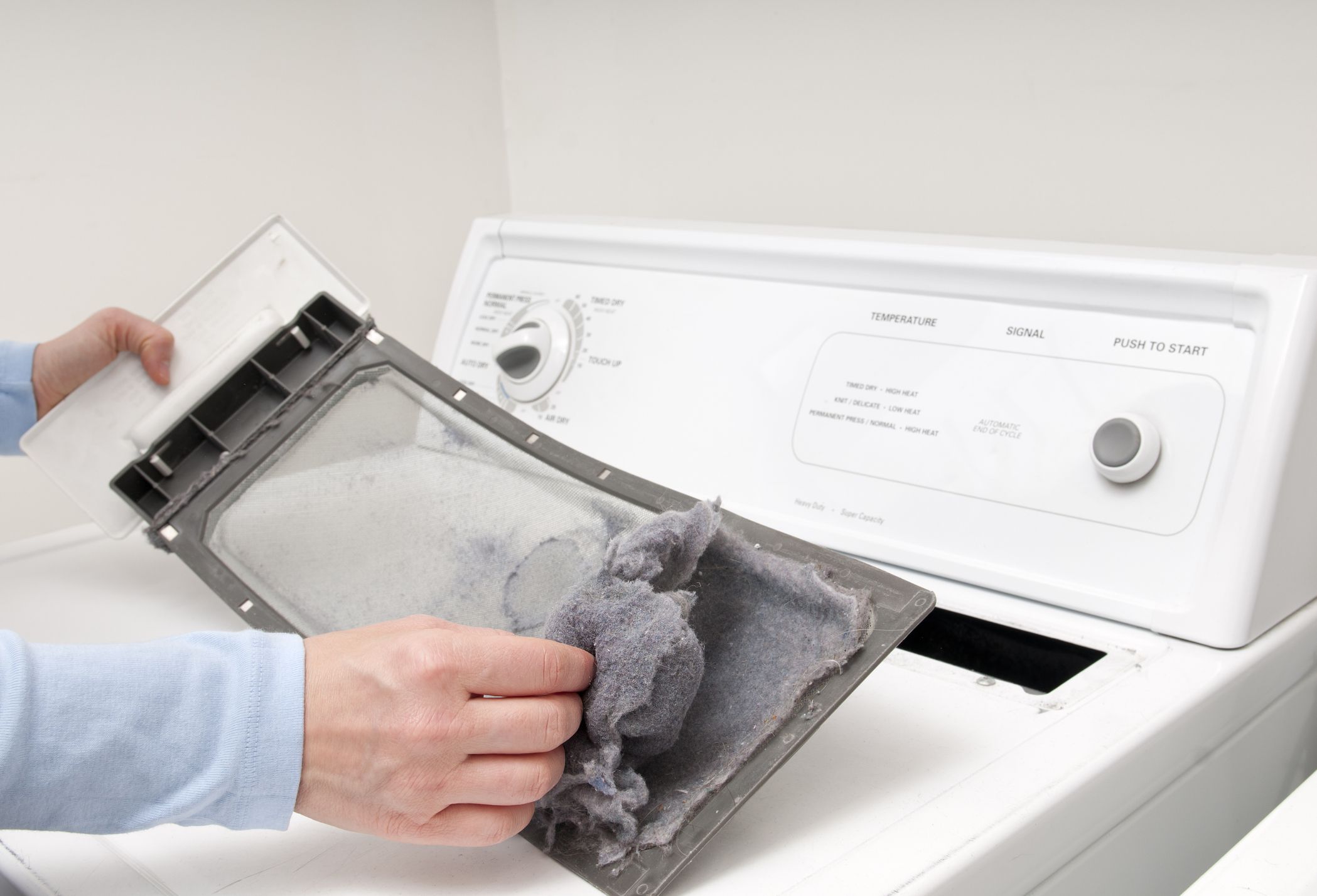Cleaning the clothes dryer lint trap. Please see my portfolio for other home improvement images.