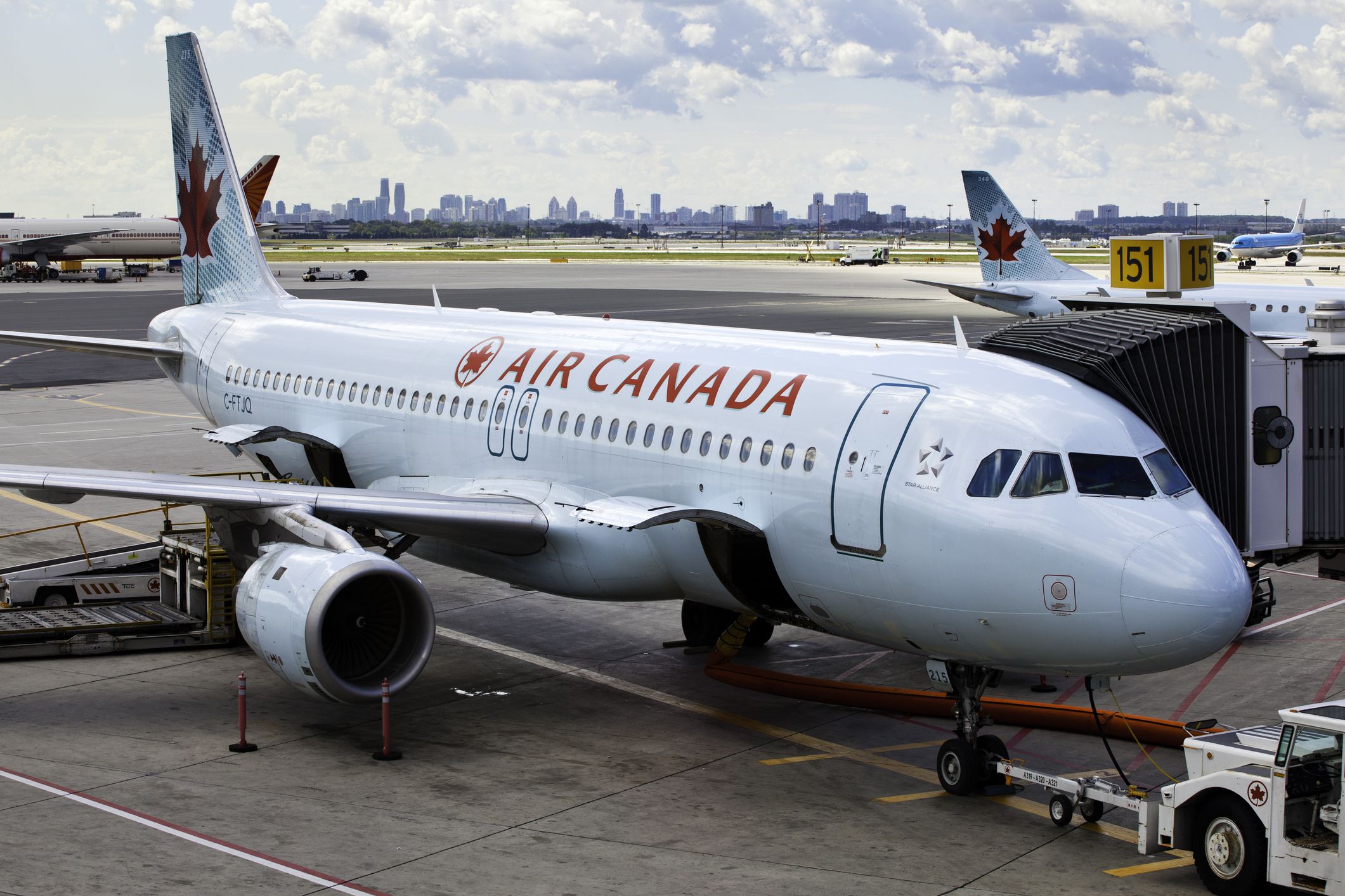 Toronto, Ontario, Canada - August 29, 2011: At Toronto Pearson International Airport, a commercial, Air Canada jet is being loaded and prepped for departure. Doors open on aircraft ready to loading baggage.