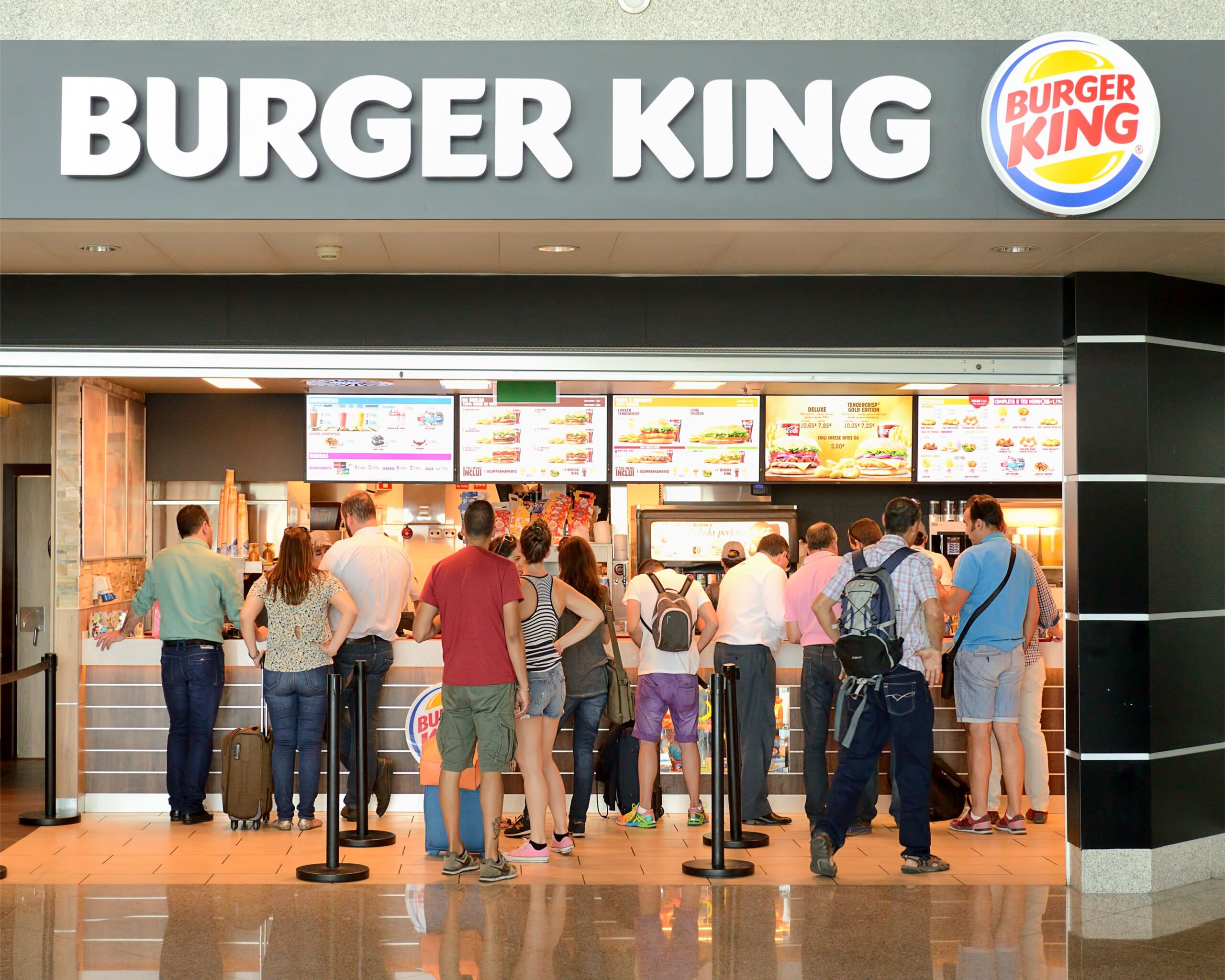Porto, Portugal- July 9, 2015: Burger King restaurant at the Francisco Sá Carneiro Airport in Porto. People in line to buy food.