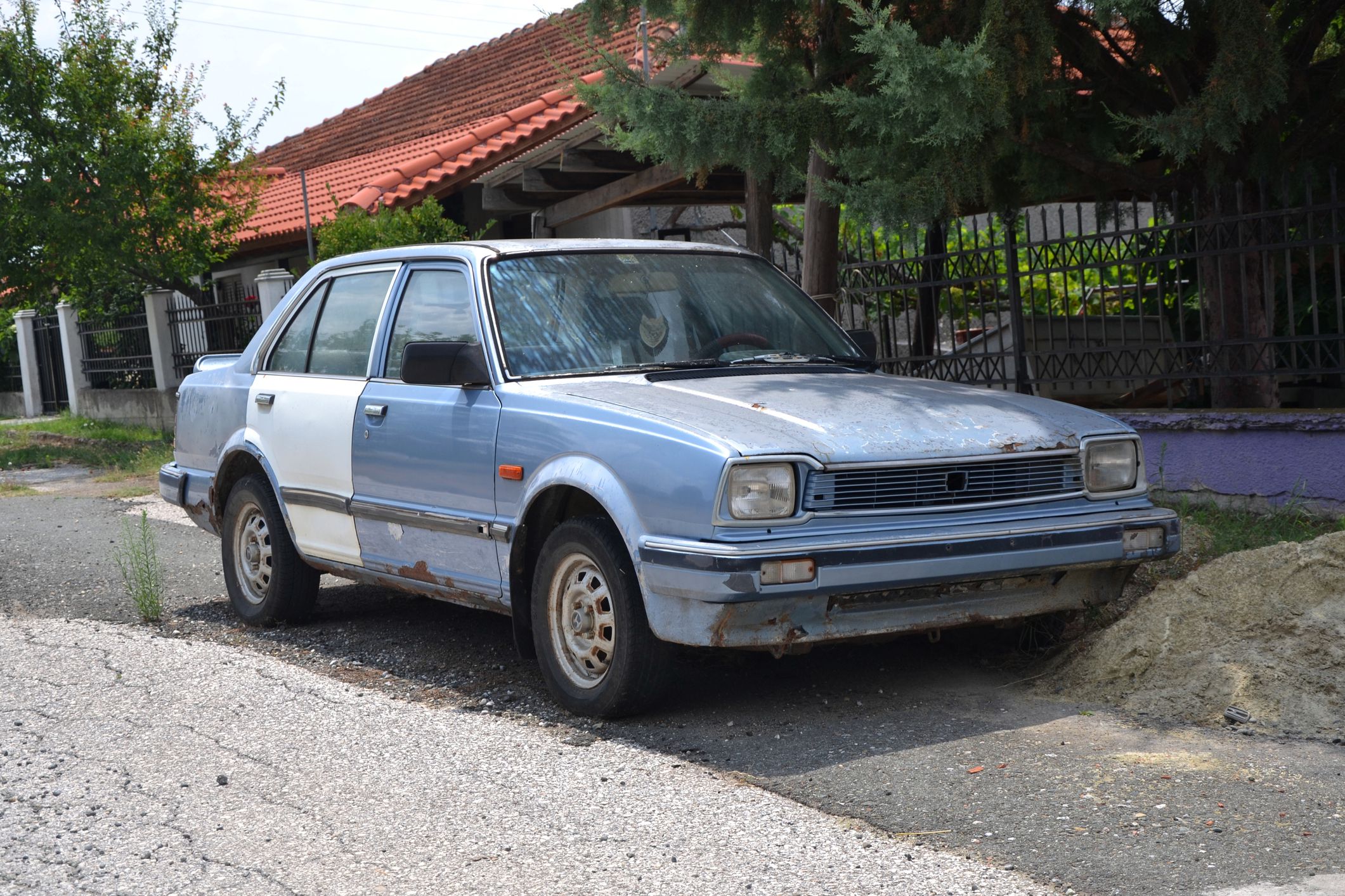 Athens, Greece - August 10th, 2013: Old Honda Civic II sedan dying on the street. The second generation of Civic (1979-1983) was the most popular Honda car in 80s in the world.
