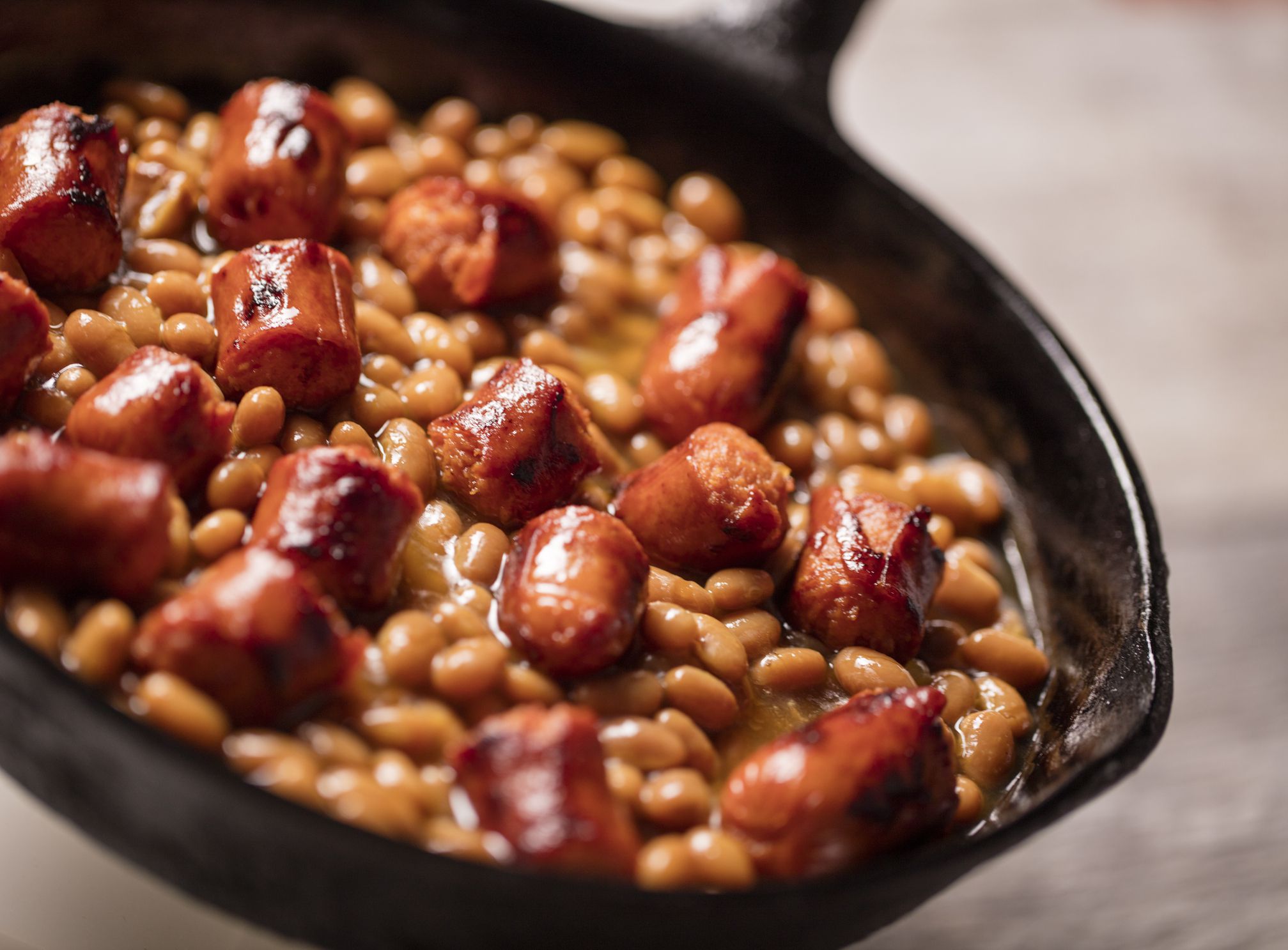 Hot dogs and beans in a cast iron skillet