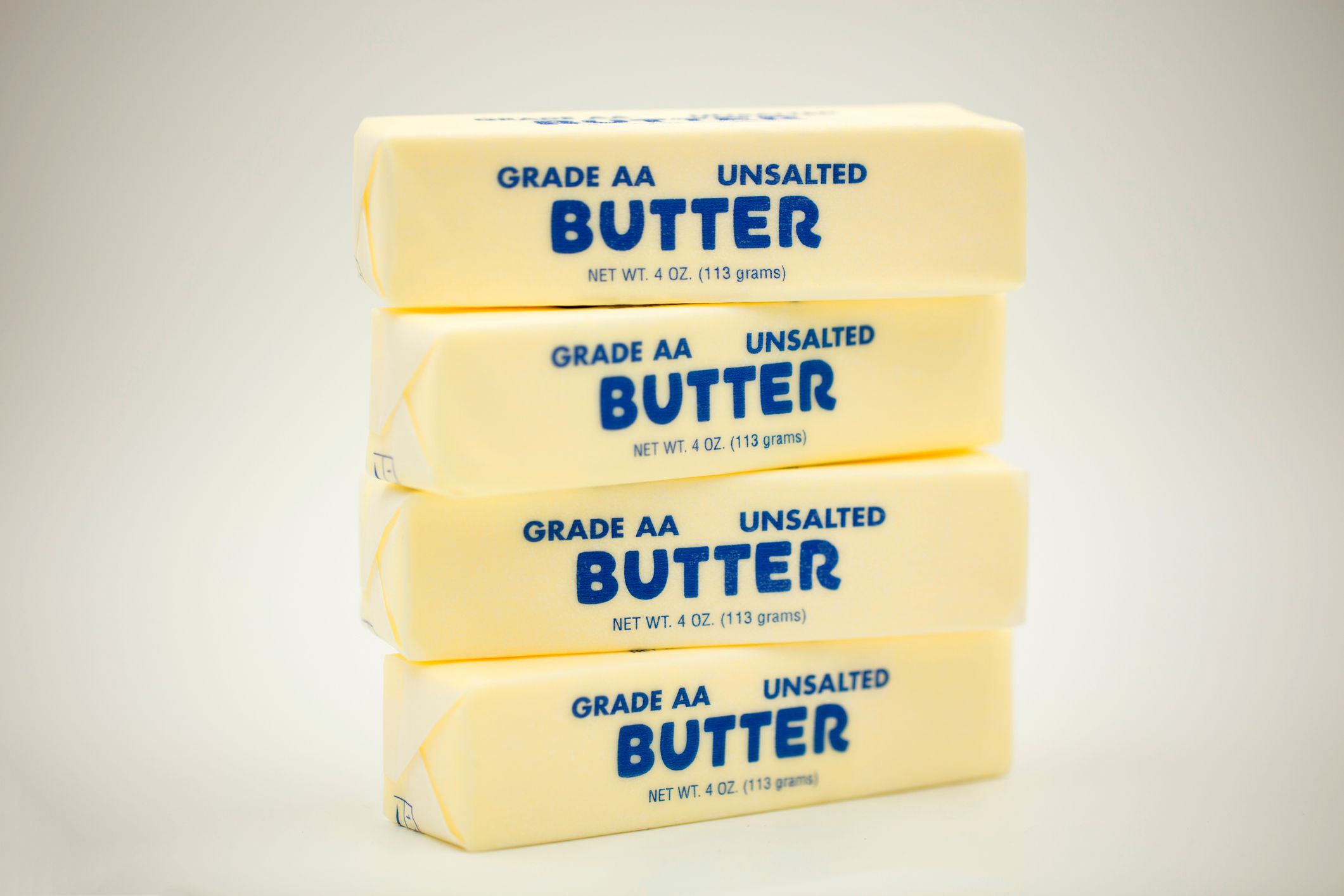 Four sticks of unsalted butter stacked on top of one another
