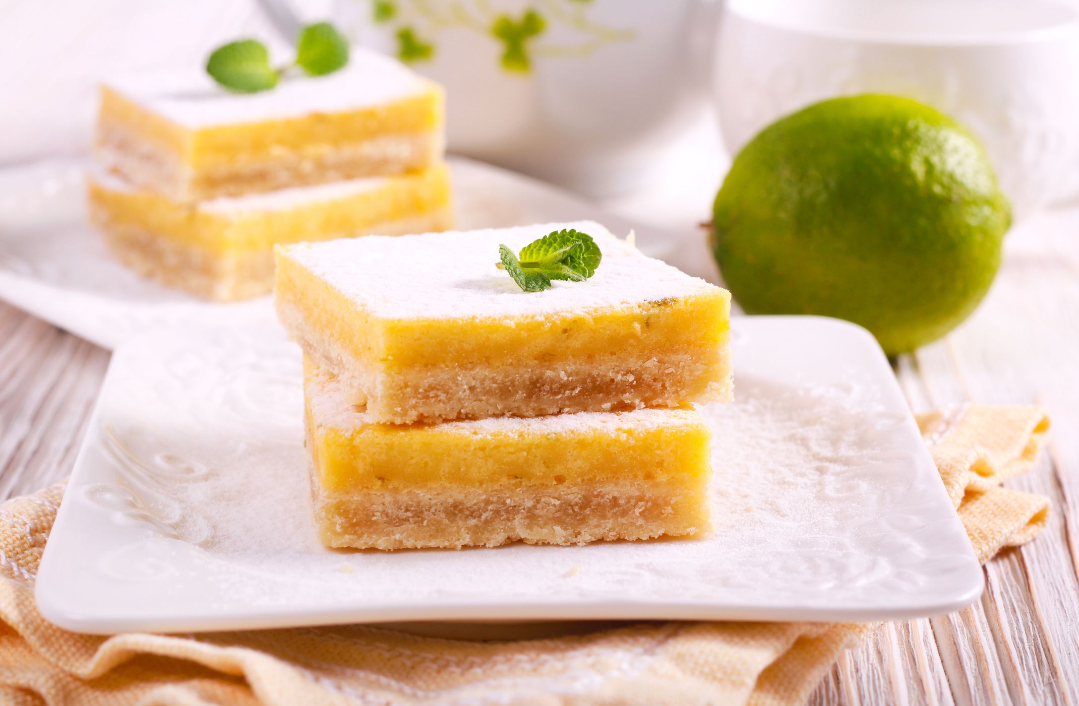 Lime cooler bars with icing sugar, served on plate