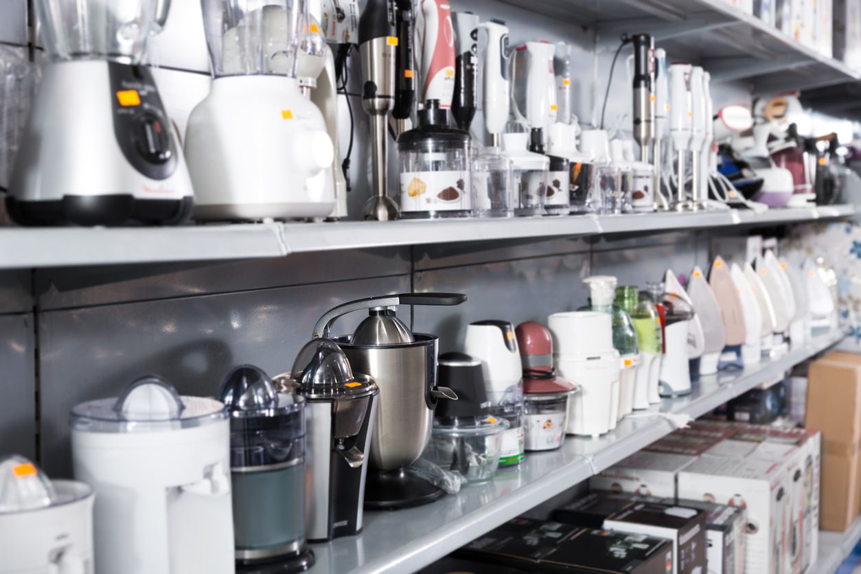 A collection of blenders on a store shelf.