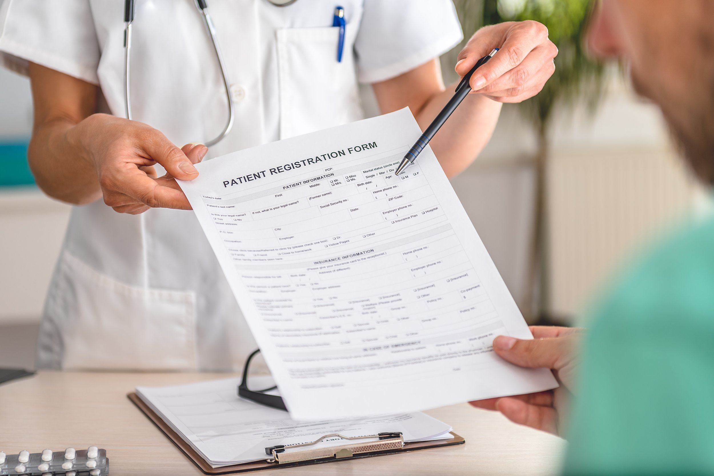 Doctor handing a patient paperwork