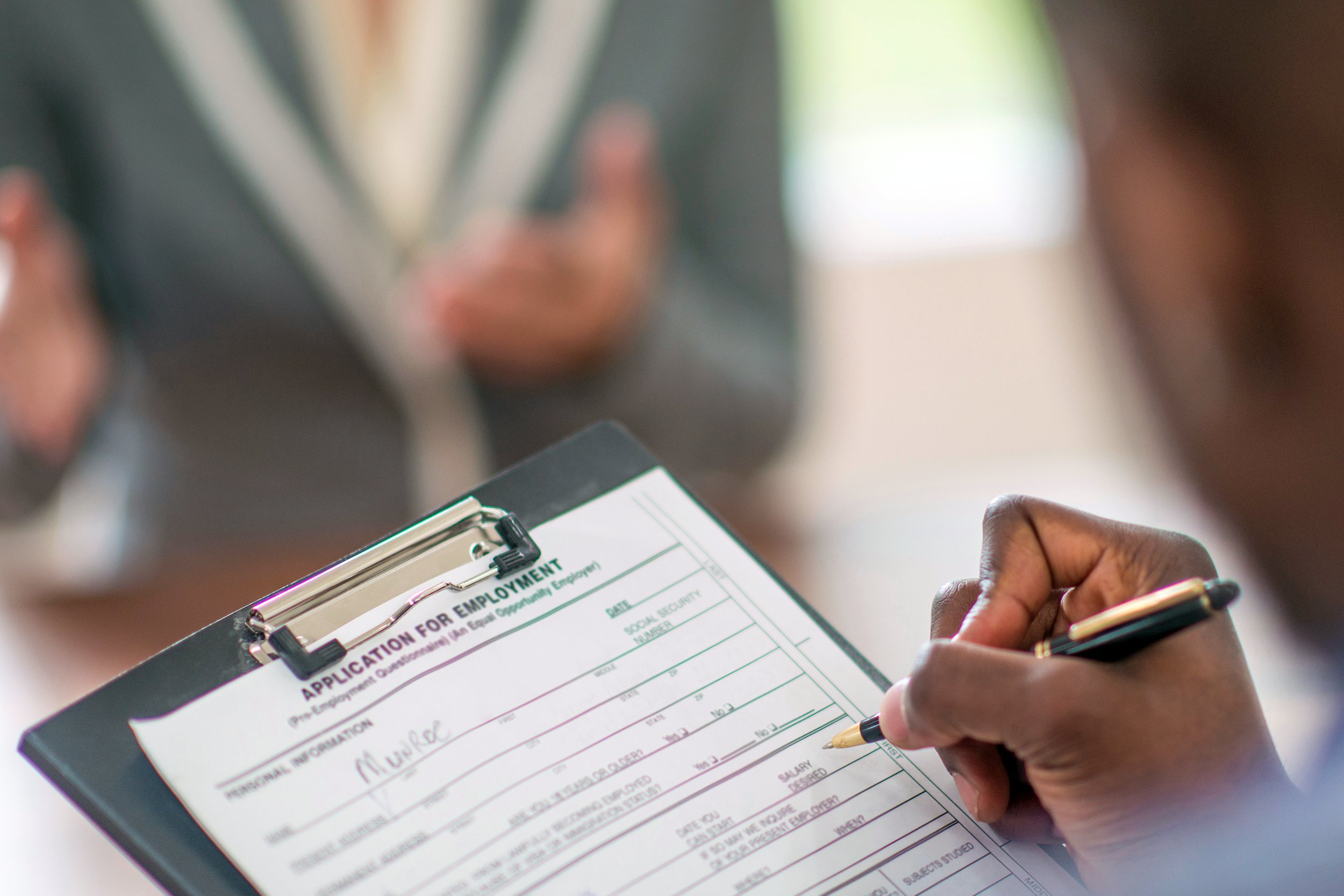 Person filling out a job application