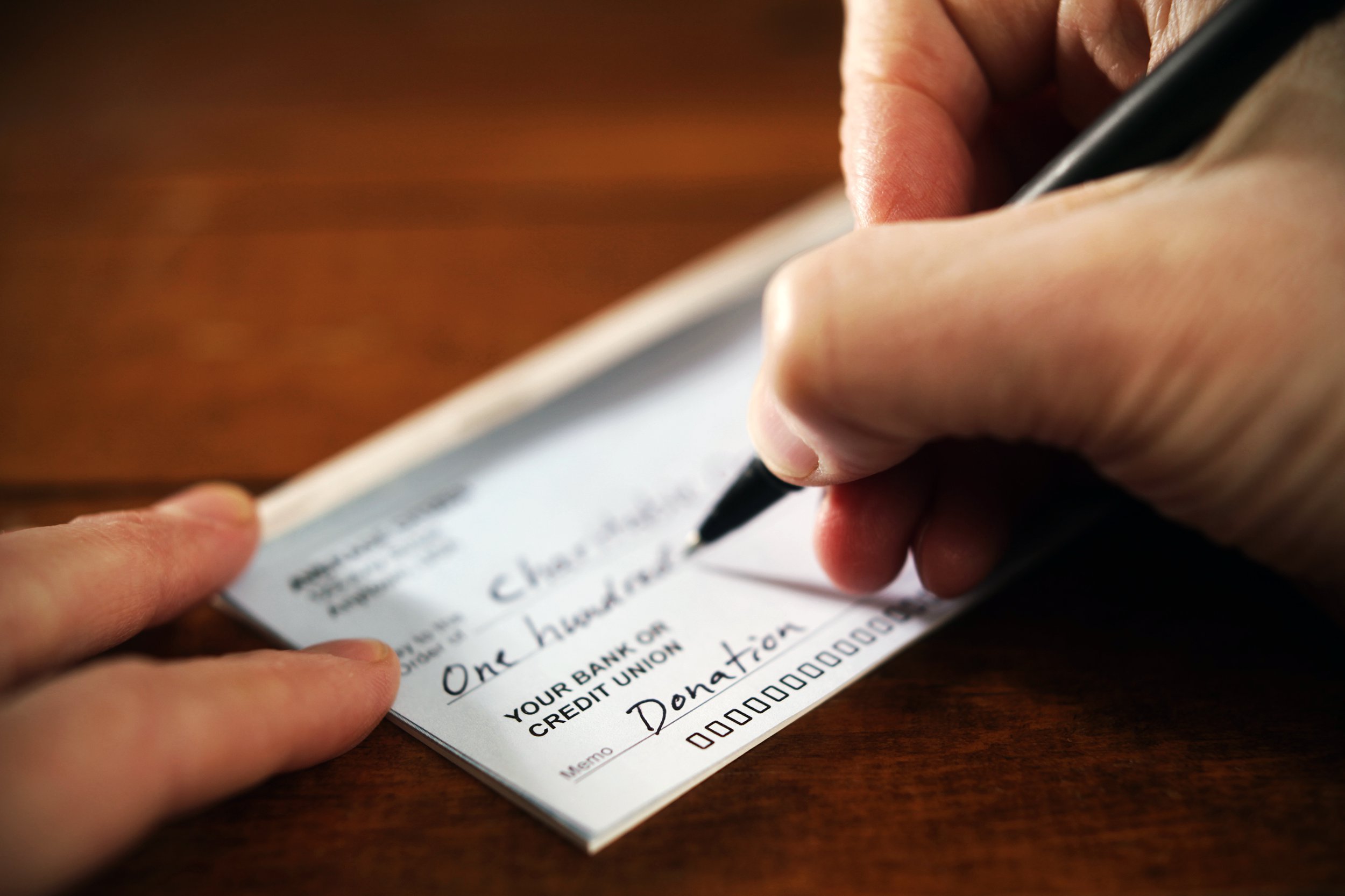Writing a donation check to a charity