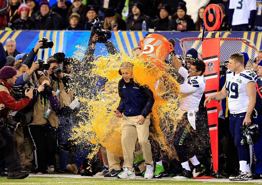 Tight end Zach Miller #86 and quarterback Russell Wilson #3 of the Seattle Seahawks dump Gatorade on head coach Pete Carroll in the fourth quarter of Super Bowl XLVIII against the Denver Broncos