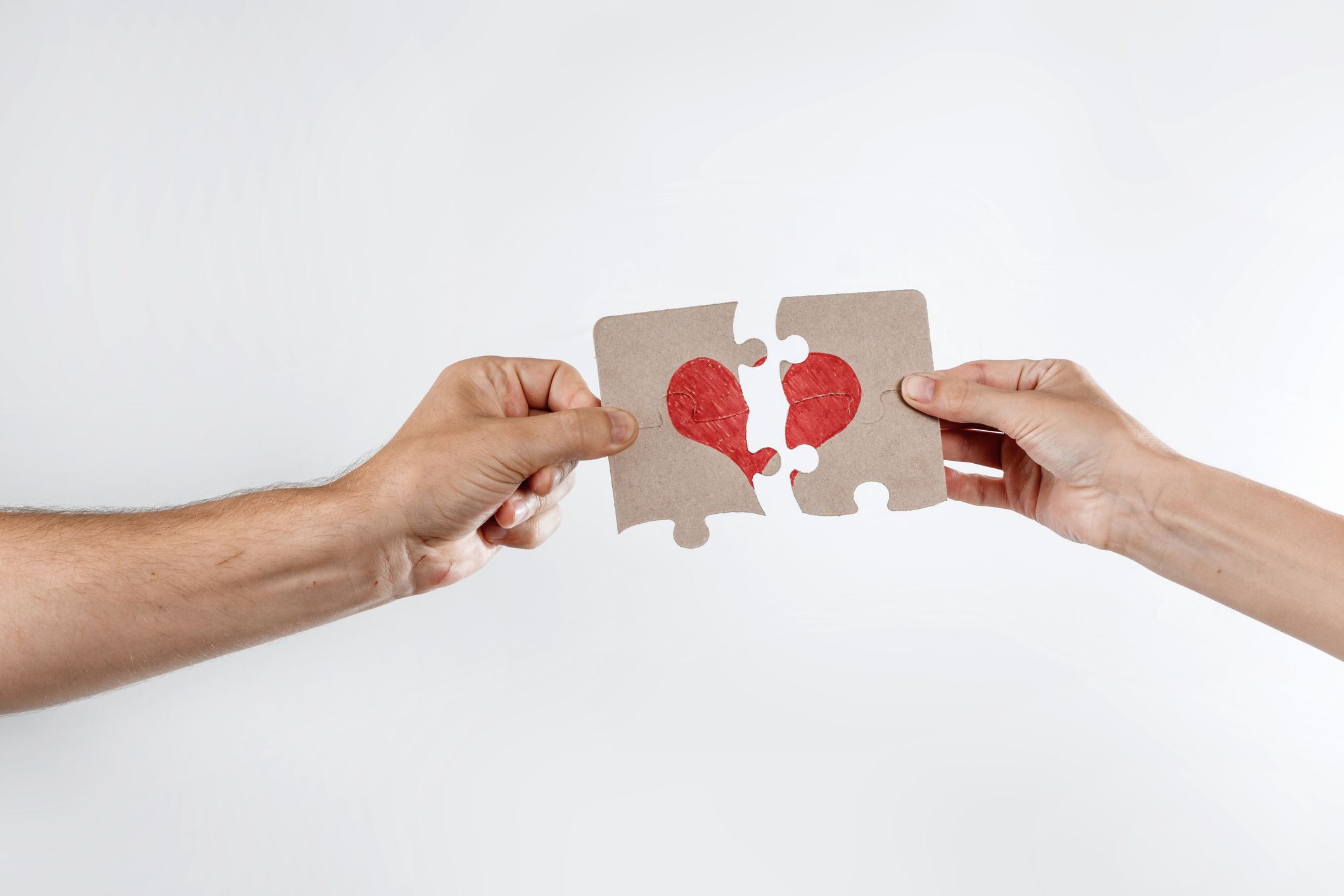 Parts of the puzzle form the heart, broken. The concept of divorce, quarrel, conflict.