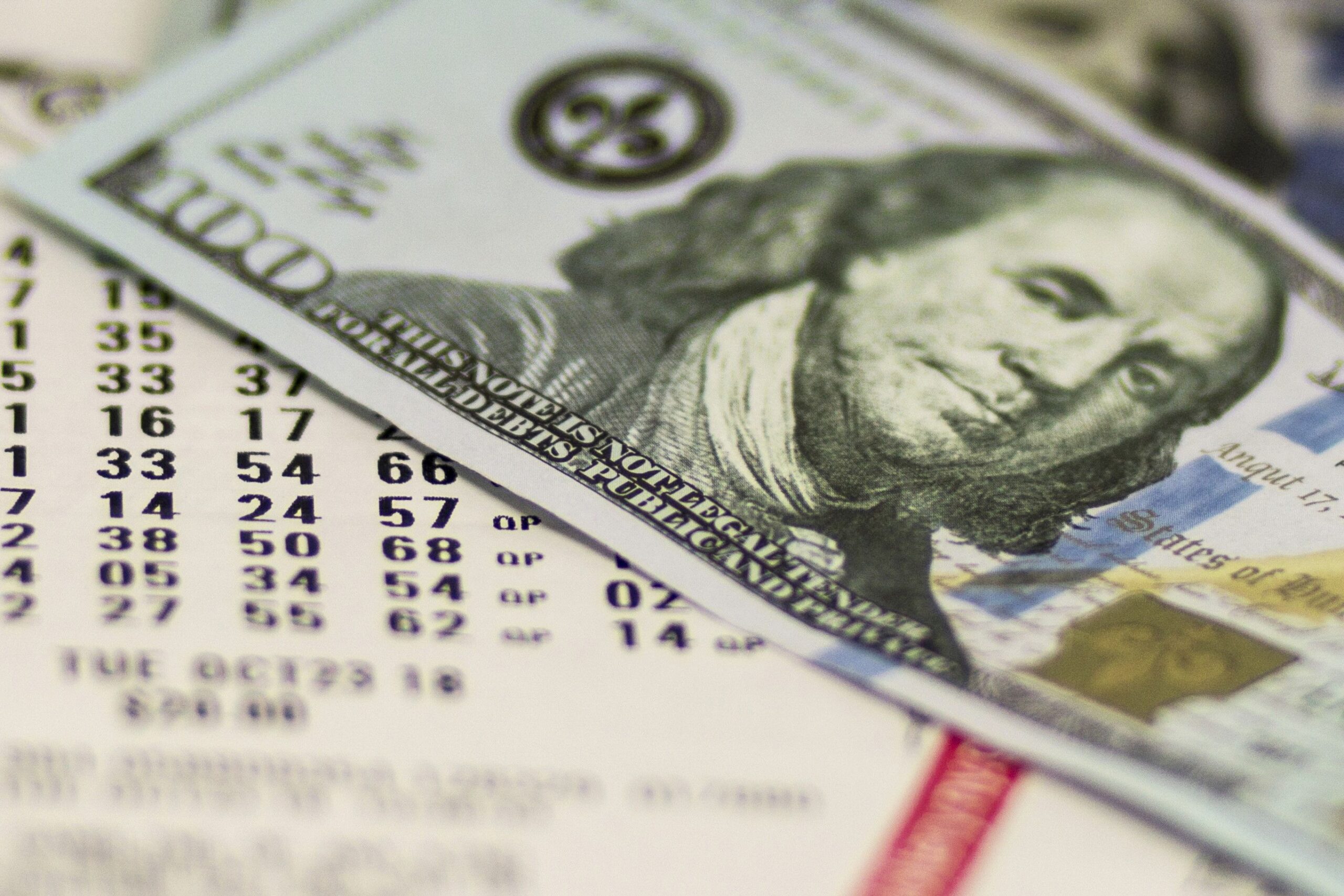 lotto ticket and $100 bill