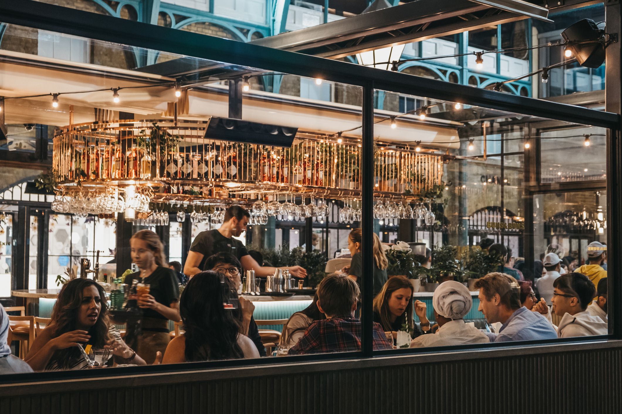 London, UK - August 31, 2019: View through the window of staff and customers inside Buns and Buns restaurant in Covent Garden Market, one of the most popular tourist sites in London, UK.