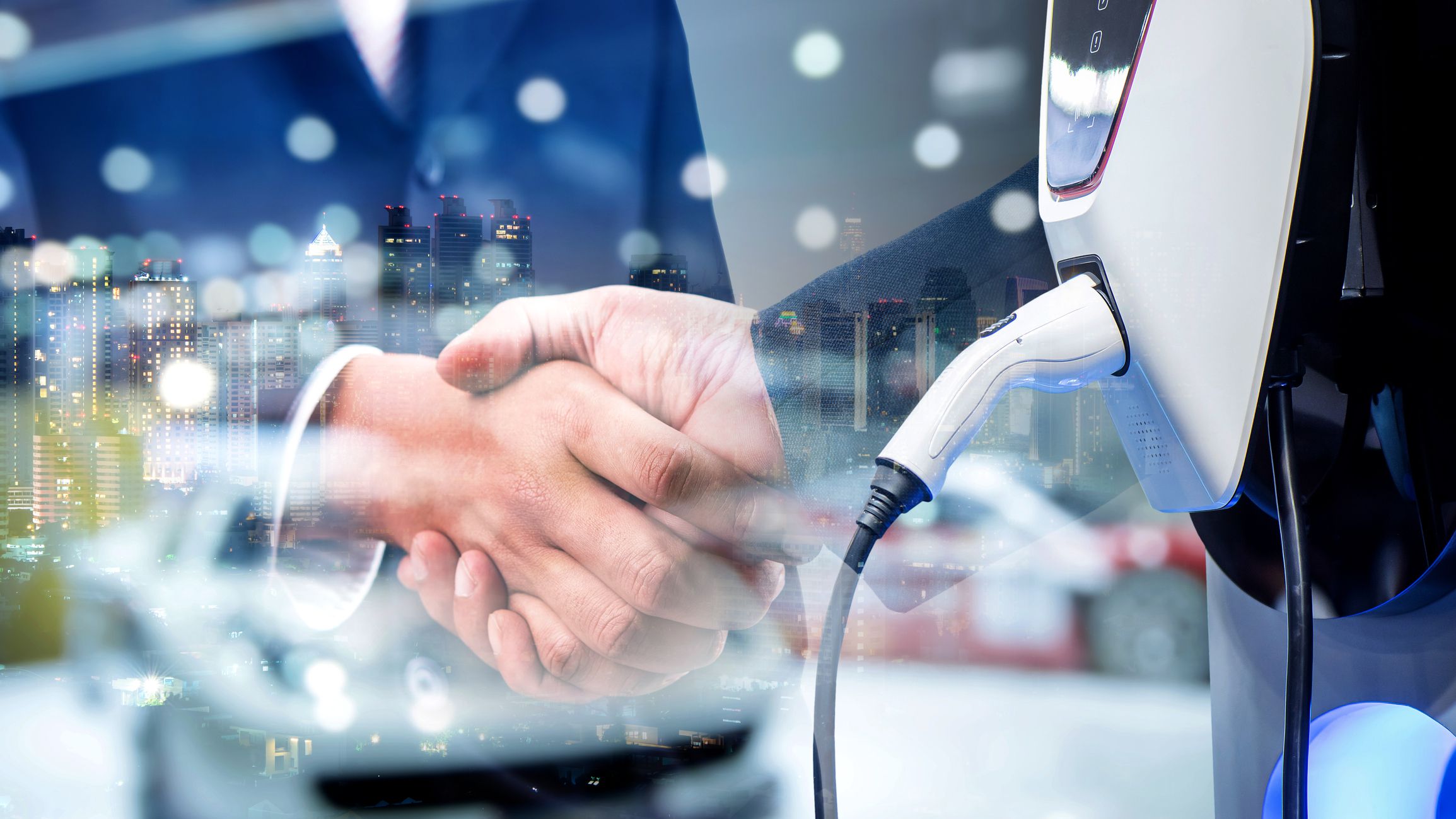 Business people shaking hands in the finishing successful meeting with charging an electric car battery, new innovative technology EV Electrical vehicle