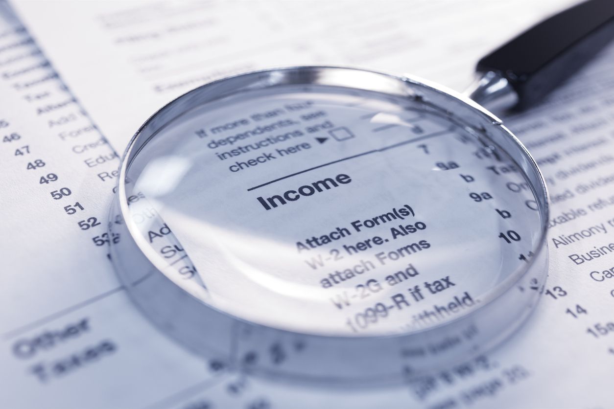A magnifying glass and a income tax return