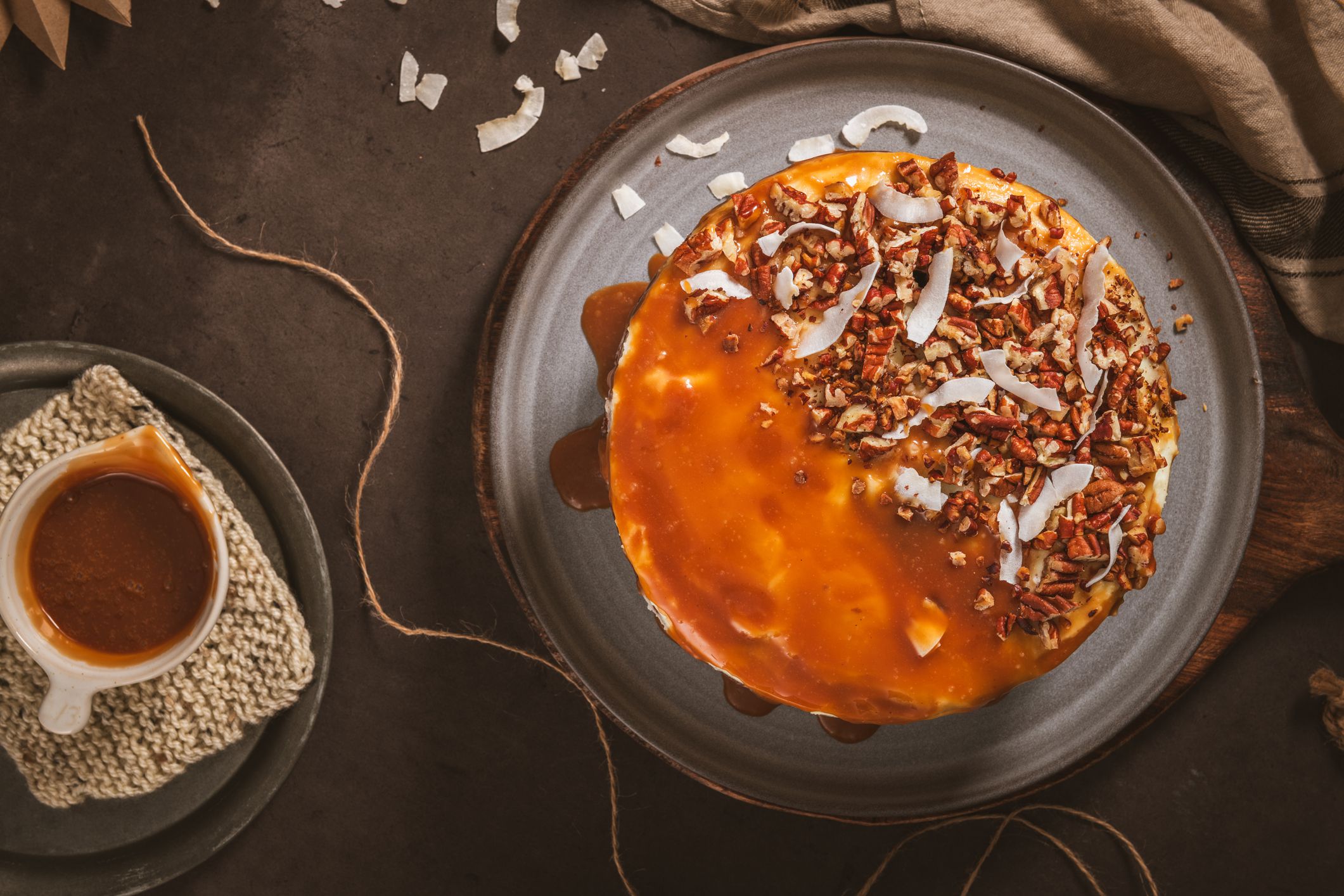 Delicious caramel cake with small pieces of pecan nuts and coconut shavings.
