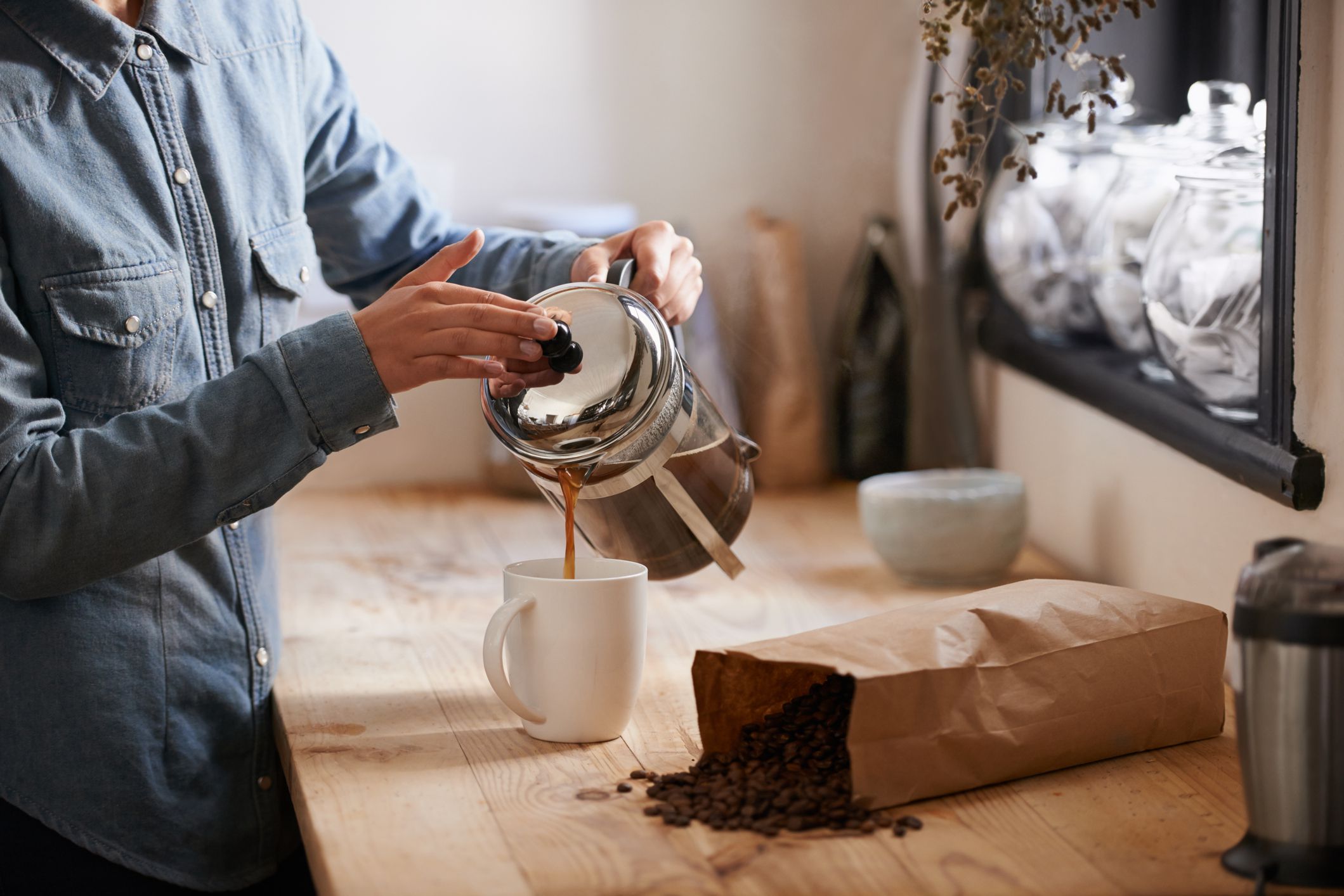 A young woman making coffee