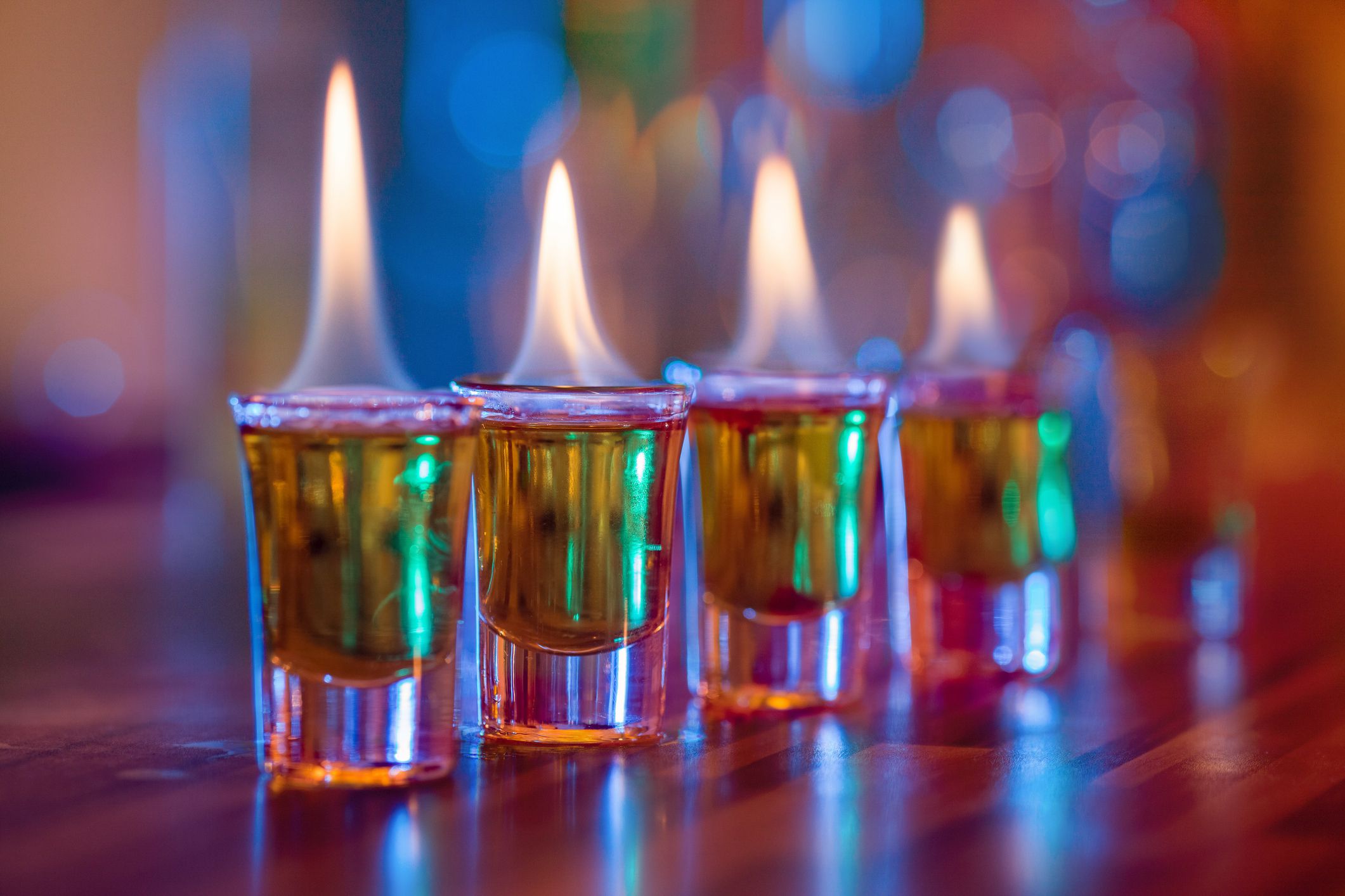 Burning cocktails in shot glass served on the bar