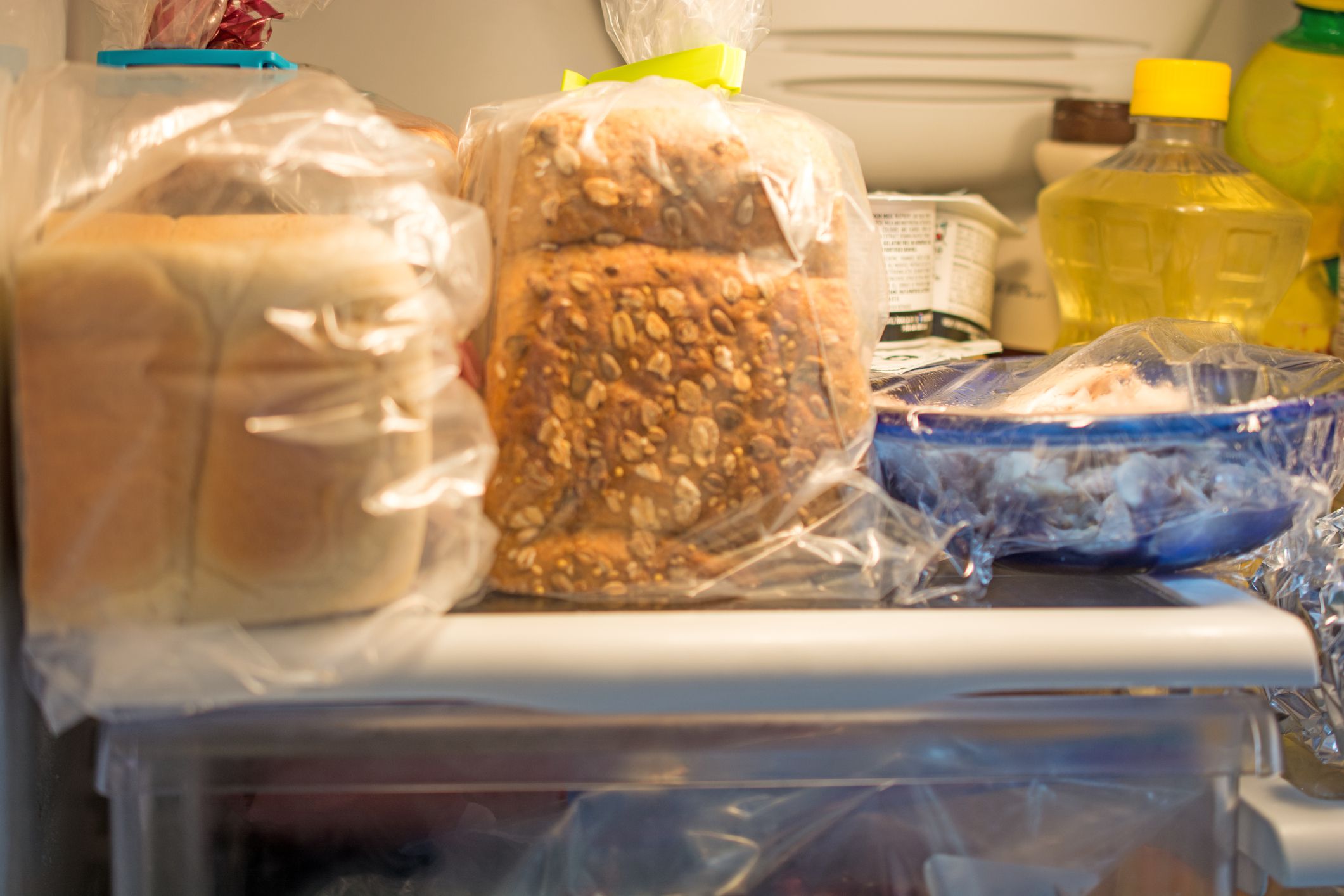 Inside a Home Fridge with bread and other articles- with fridge lighting.