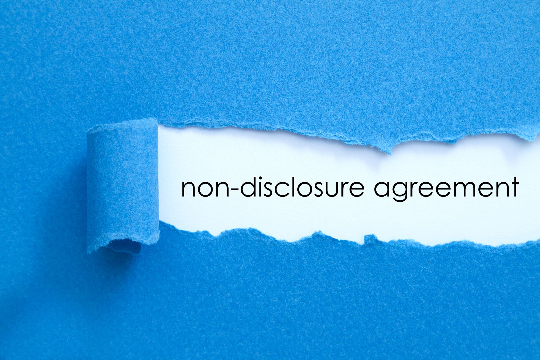 Non disclosure agreement written under torn paper.