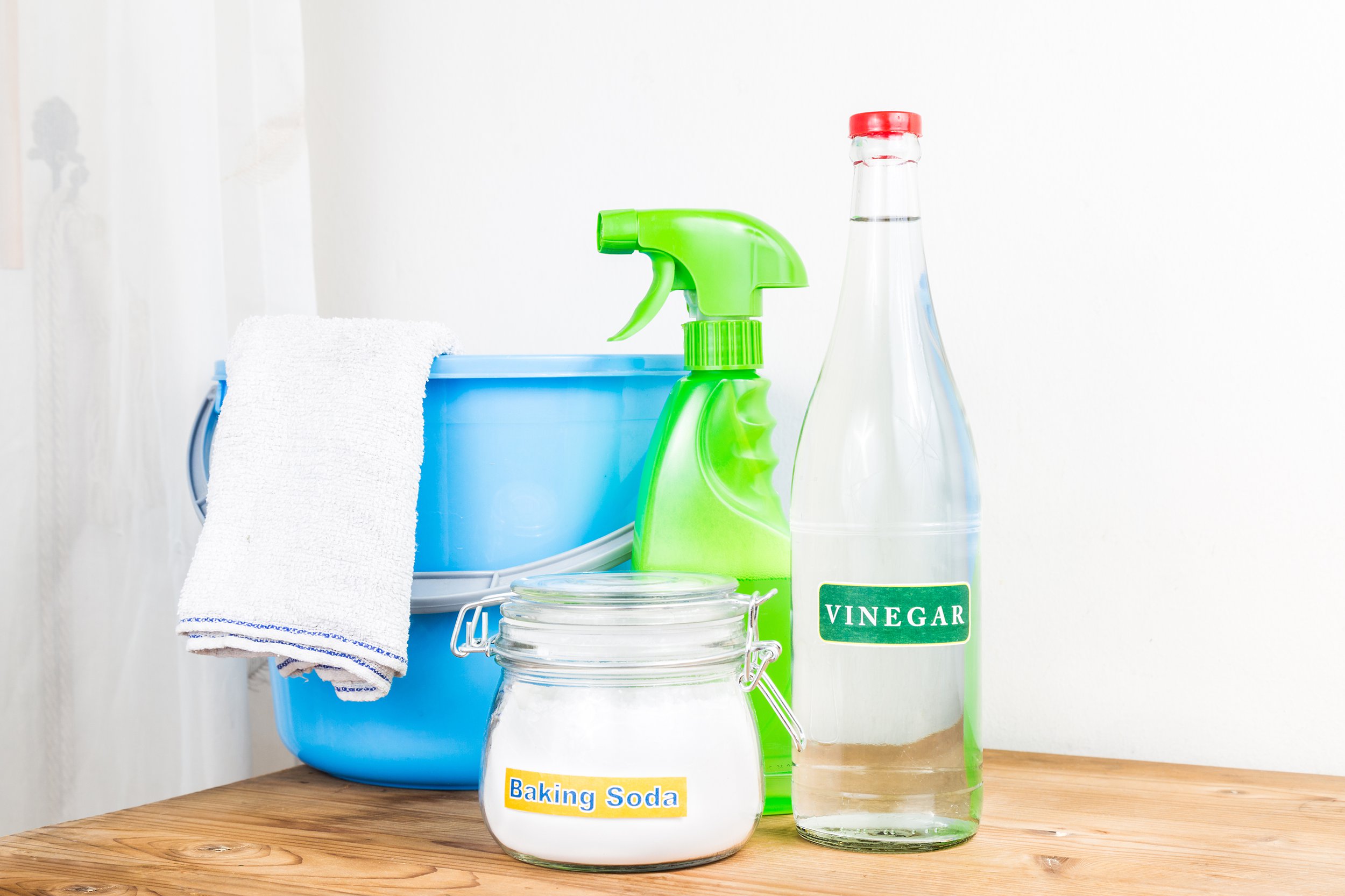 Household cleaner items including water, vinegar, and baking soda