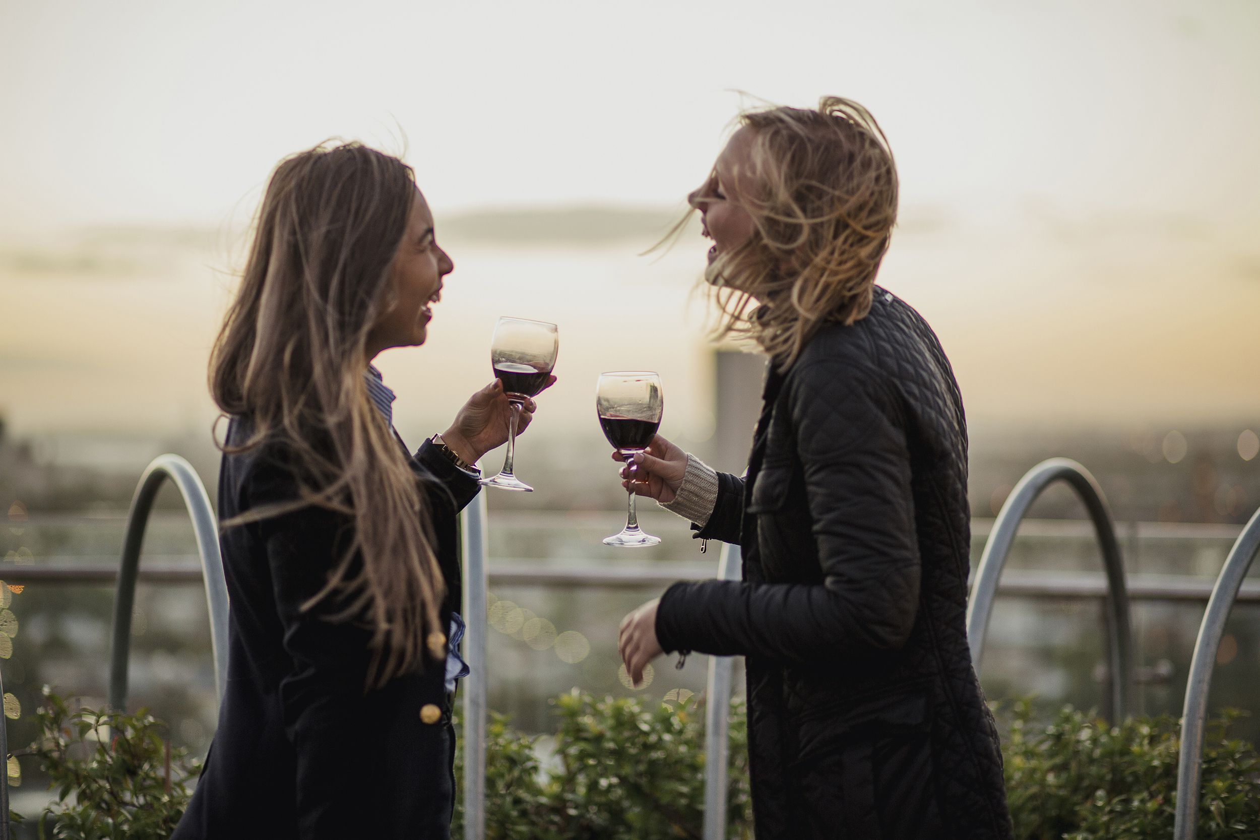 two female friends toasting on a rooftop in Melbourne, Australia