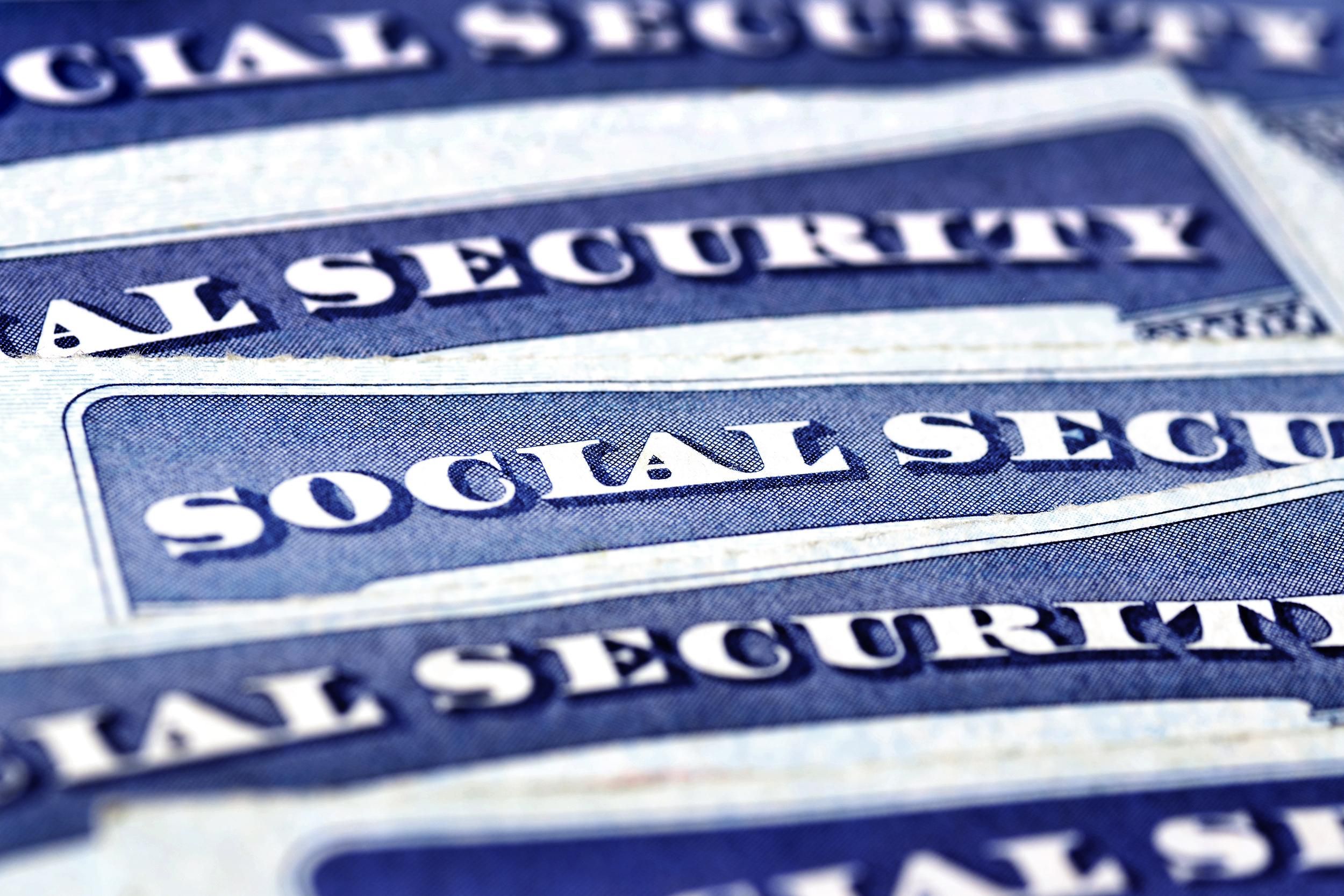 Closeup of five social security cards pile