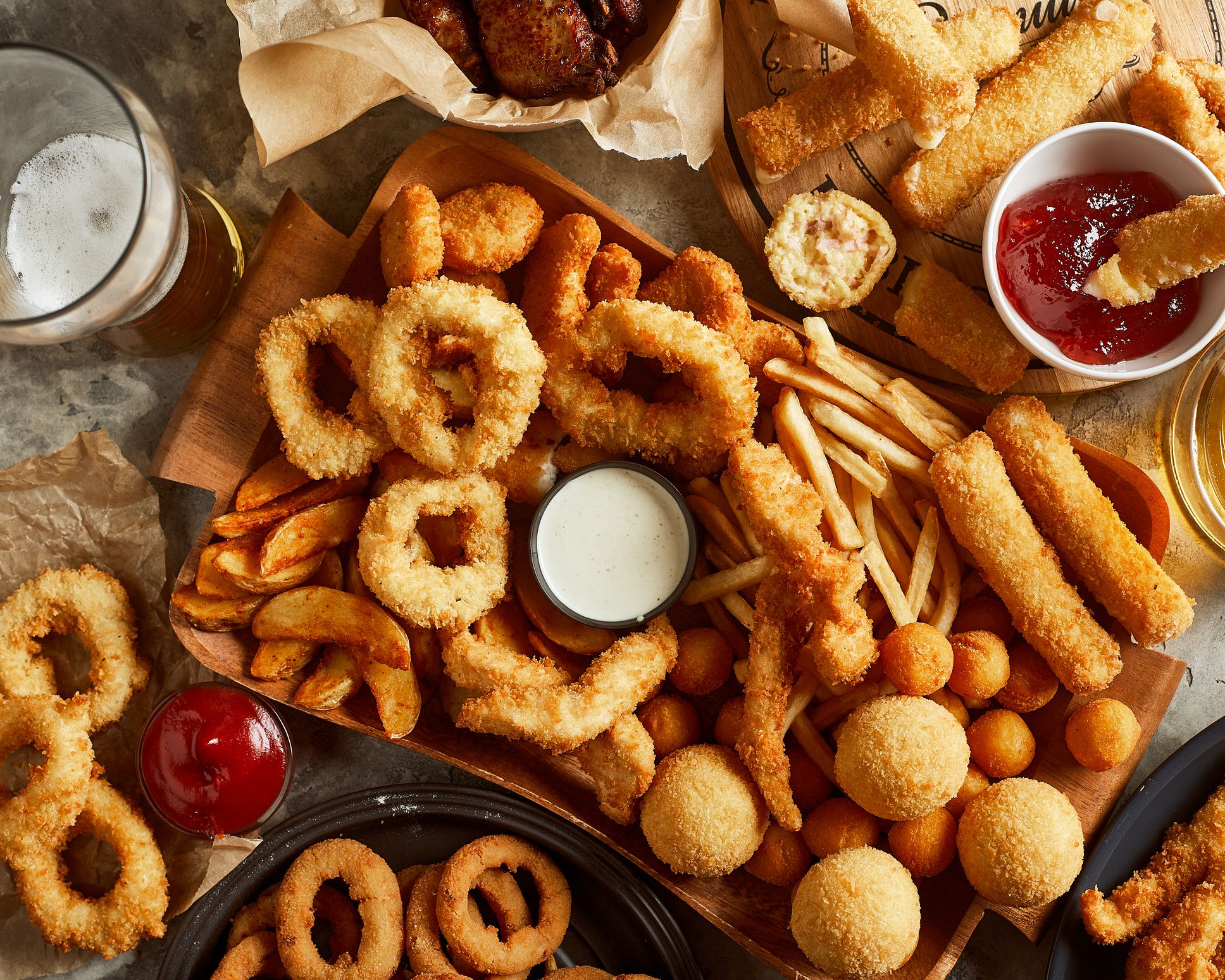 High angle view of variety of beer snack and one glass of beer