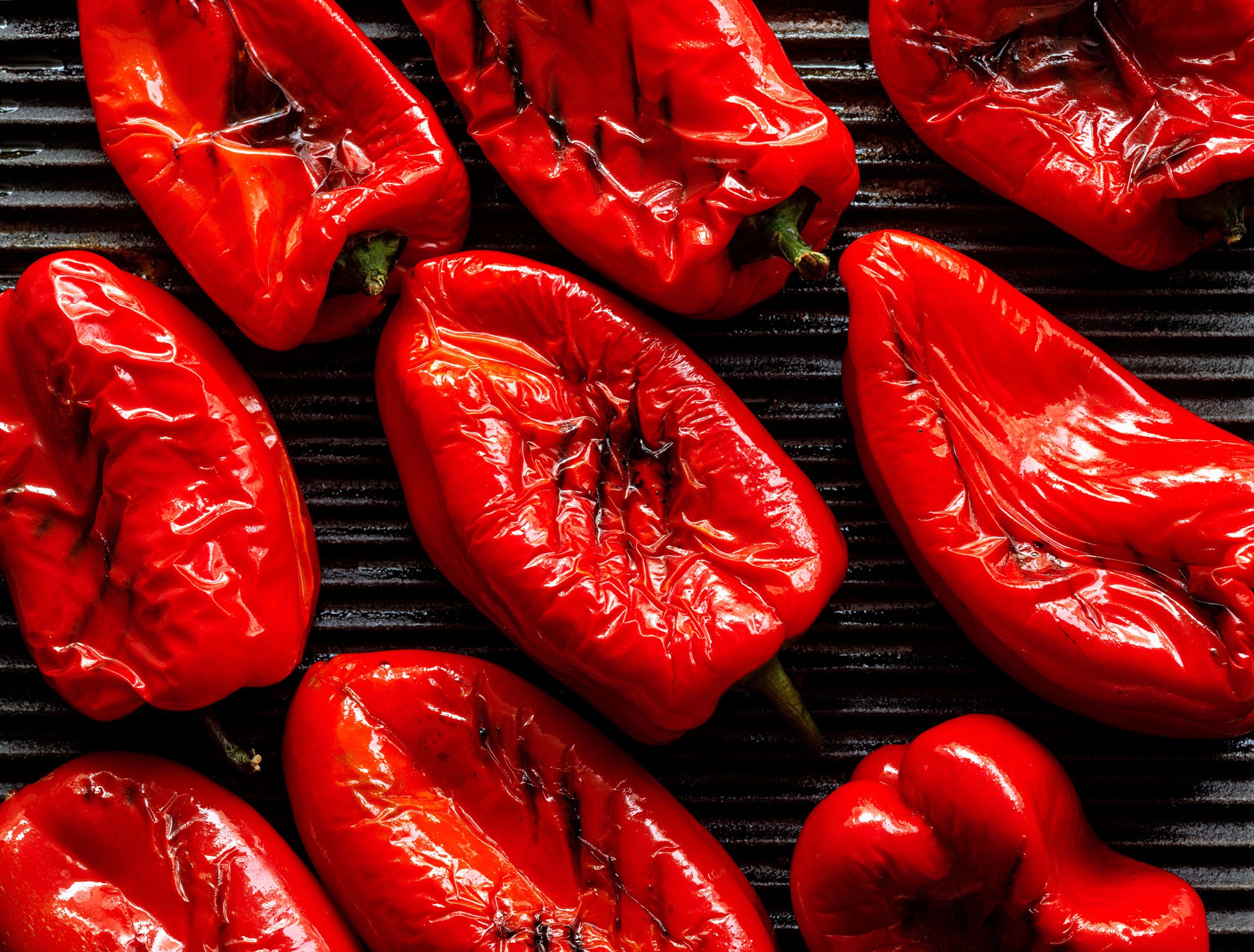 Grilled red peppers on a grill plate, close-up, top view. Vegetarian organic food