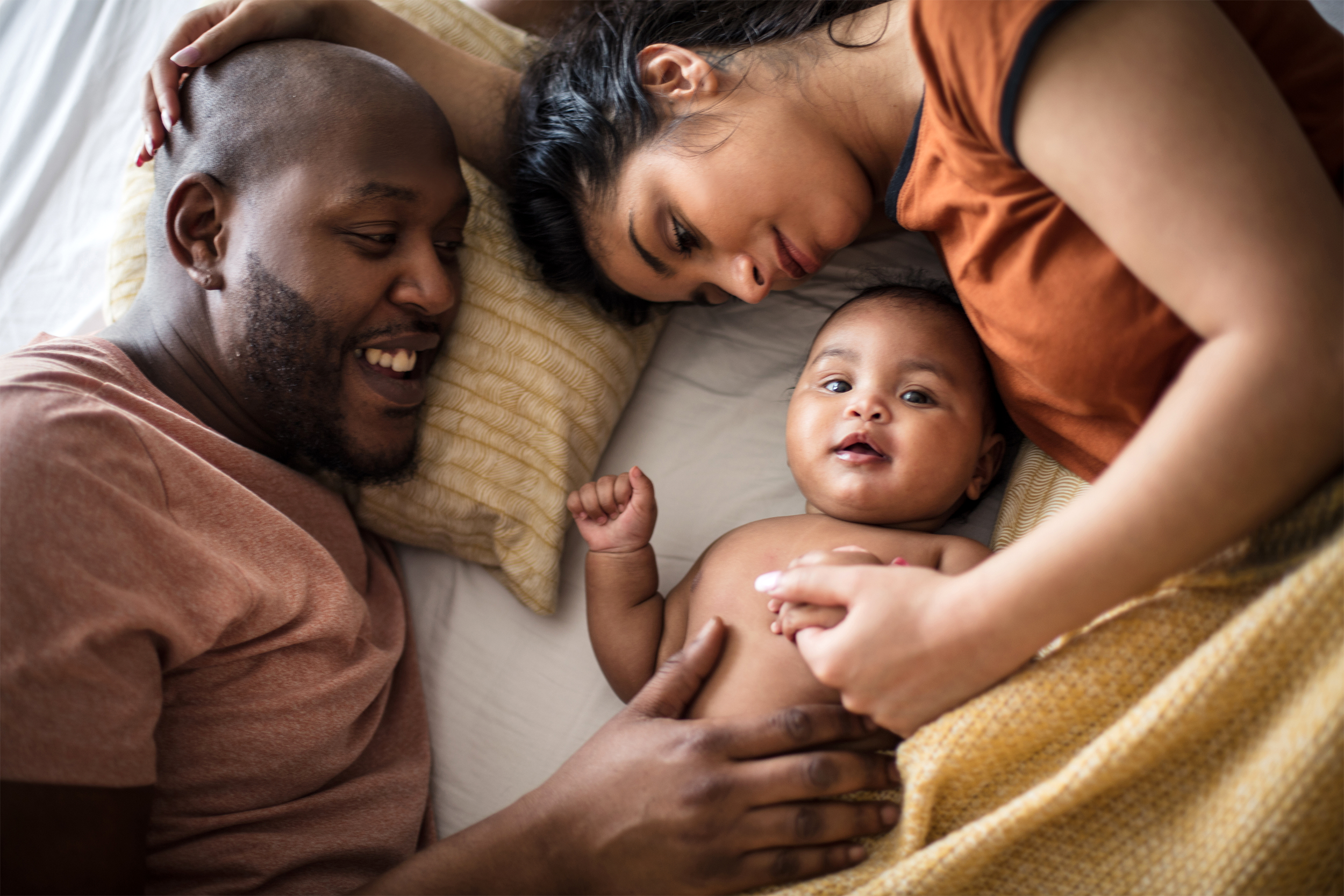 new family lying in bed