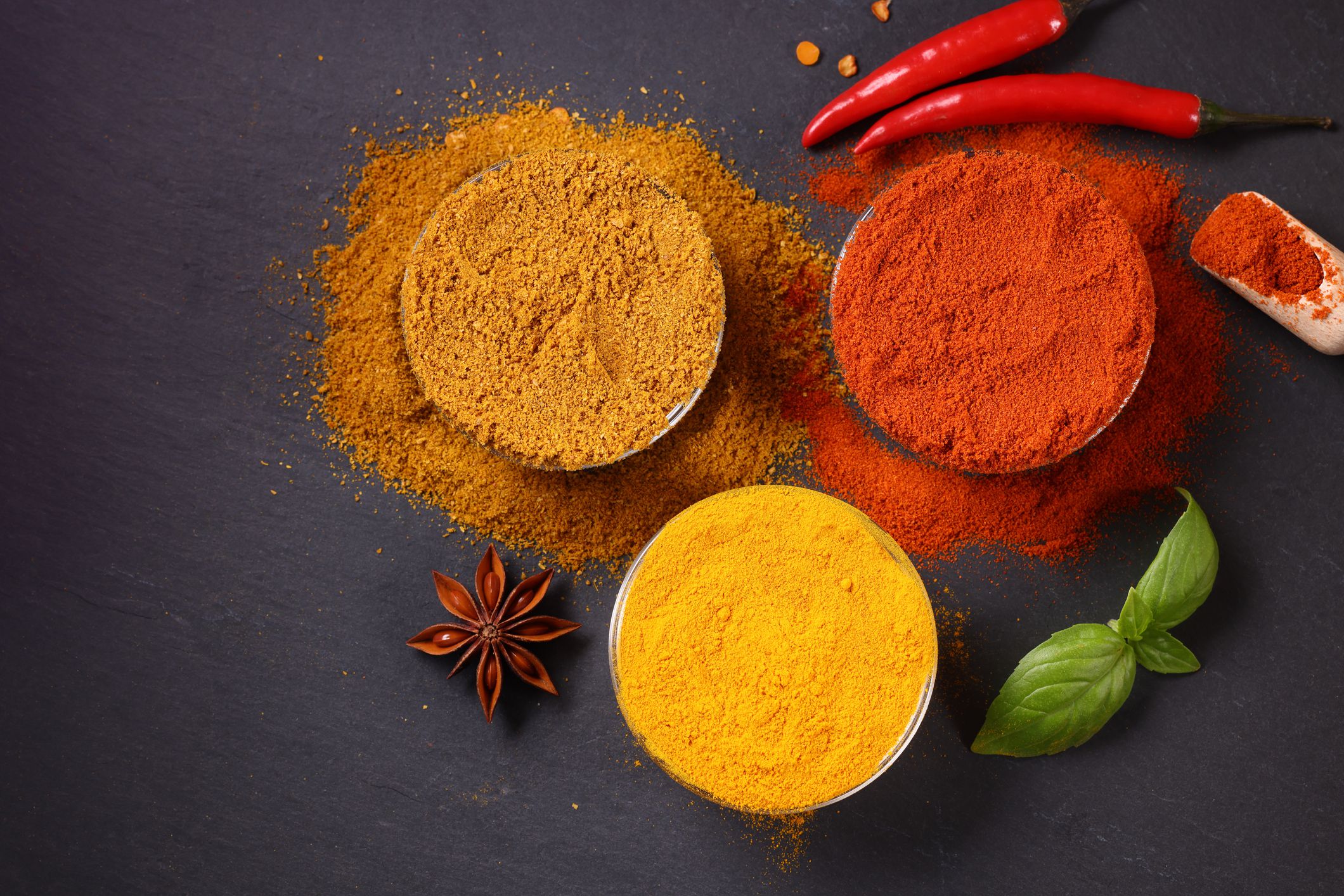 Bowls of Turmeric Chilli Pepper and Curry Powder