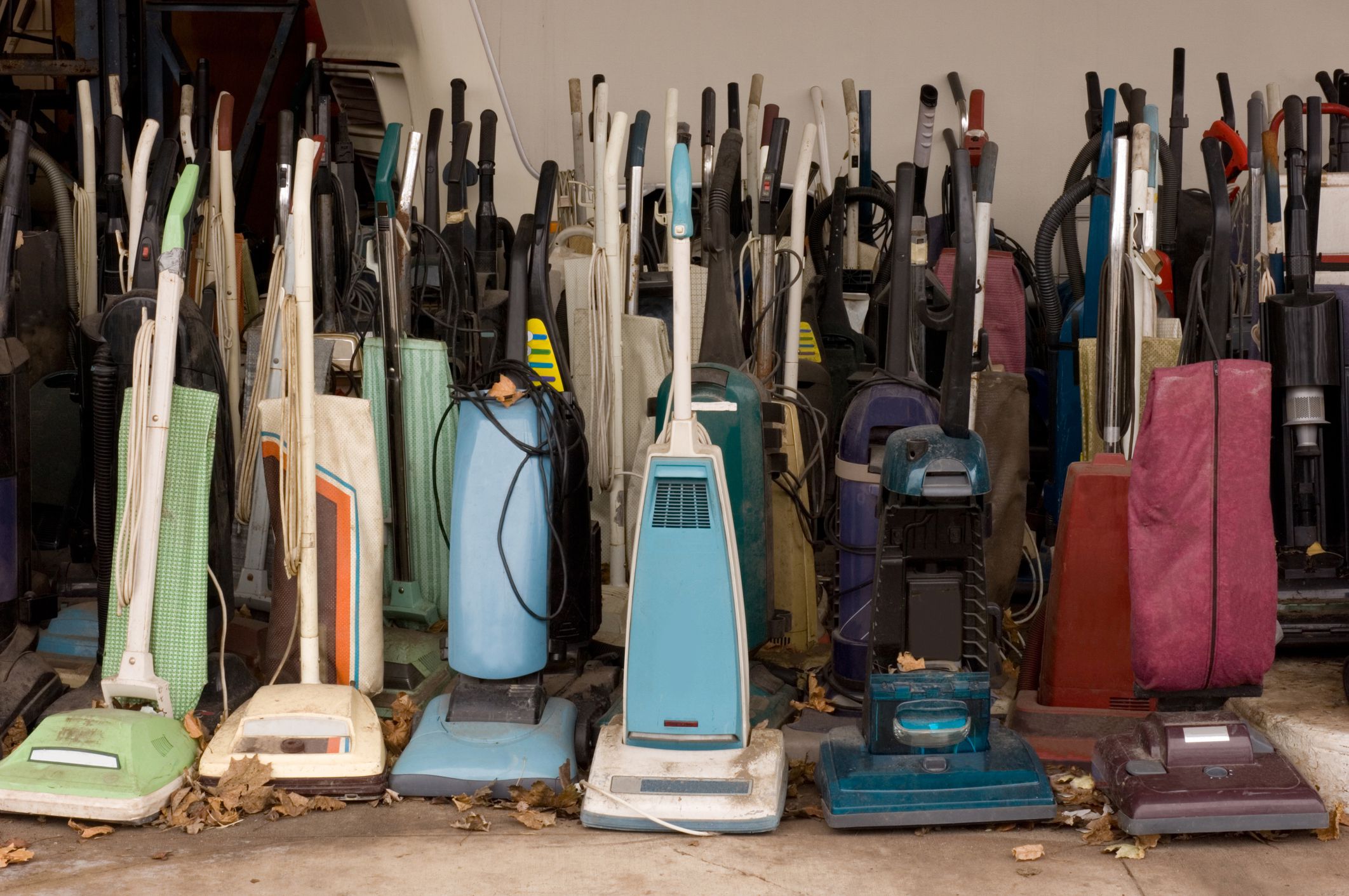 many old vacuums standing in rows facing camera