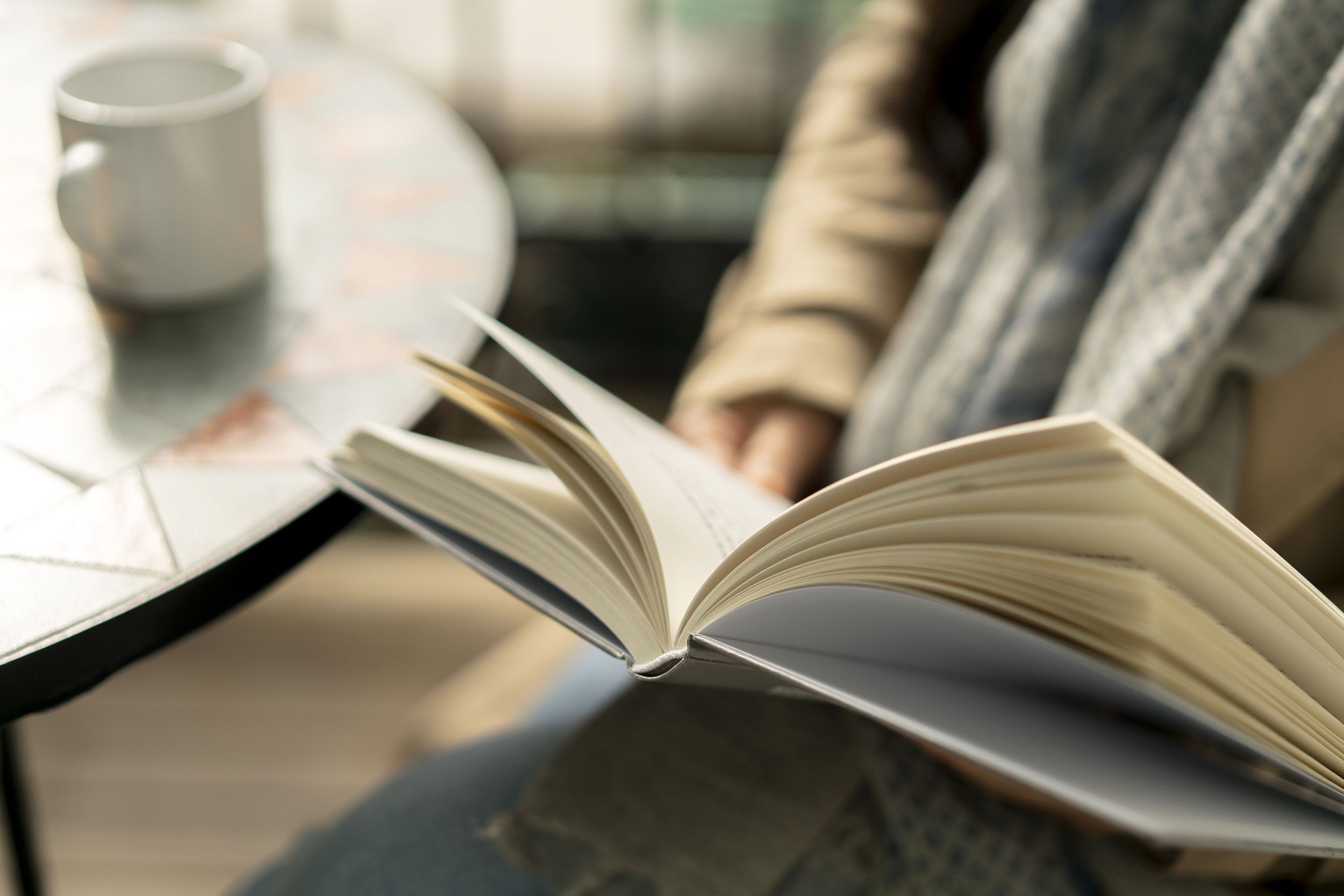 reading book while drinking coffee