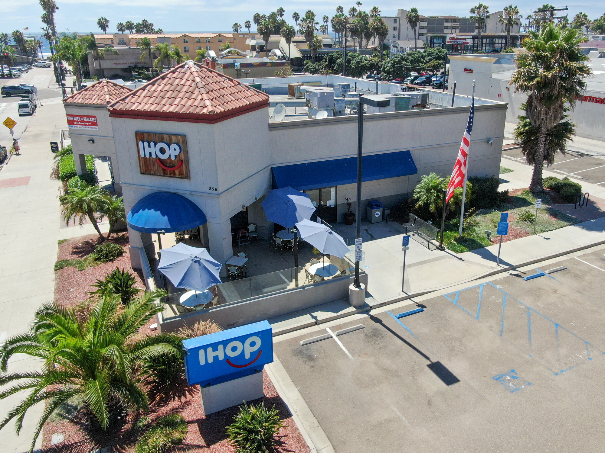 Aerial of Front Exterior of IHOP, Pacific Beach, California, With Sidewalk and Parking Lot