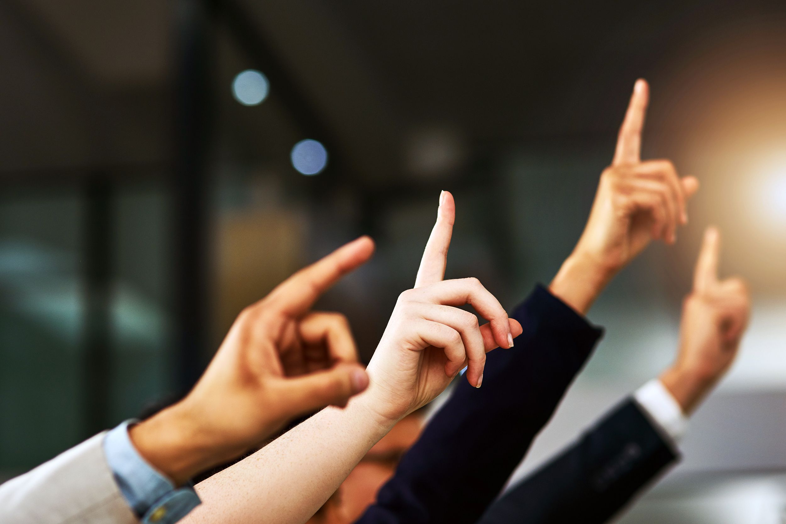 Employees raising their hands