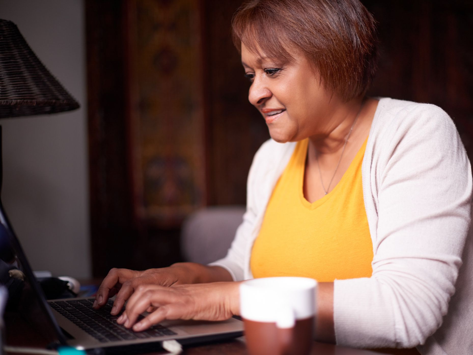 Shot of a mature woman using a laptop at home
