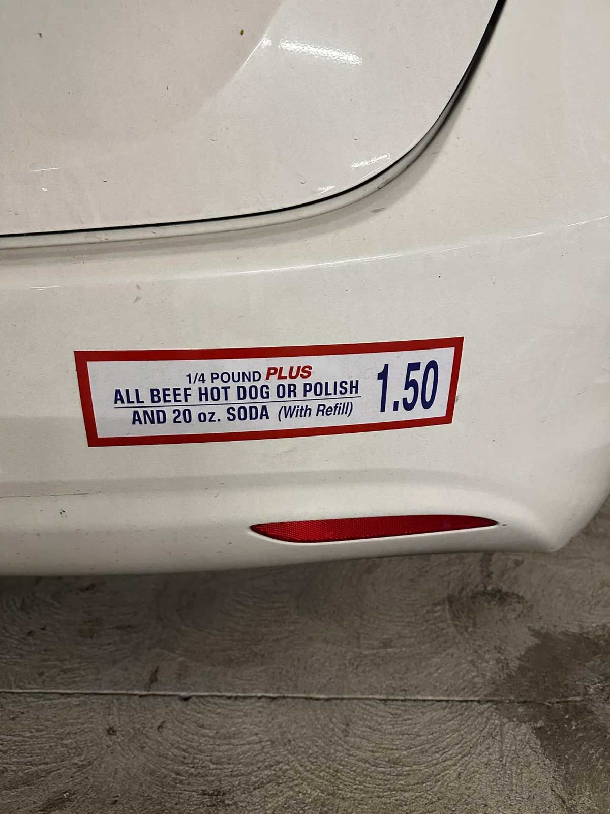 Bumper sticker on the back of a car that's the sign from the costco hot dog