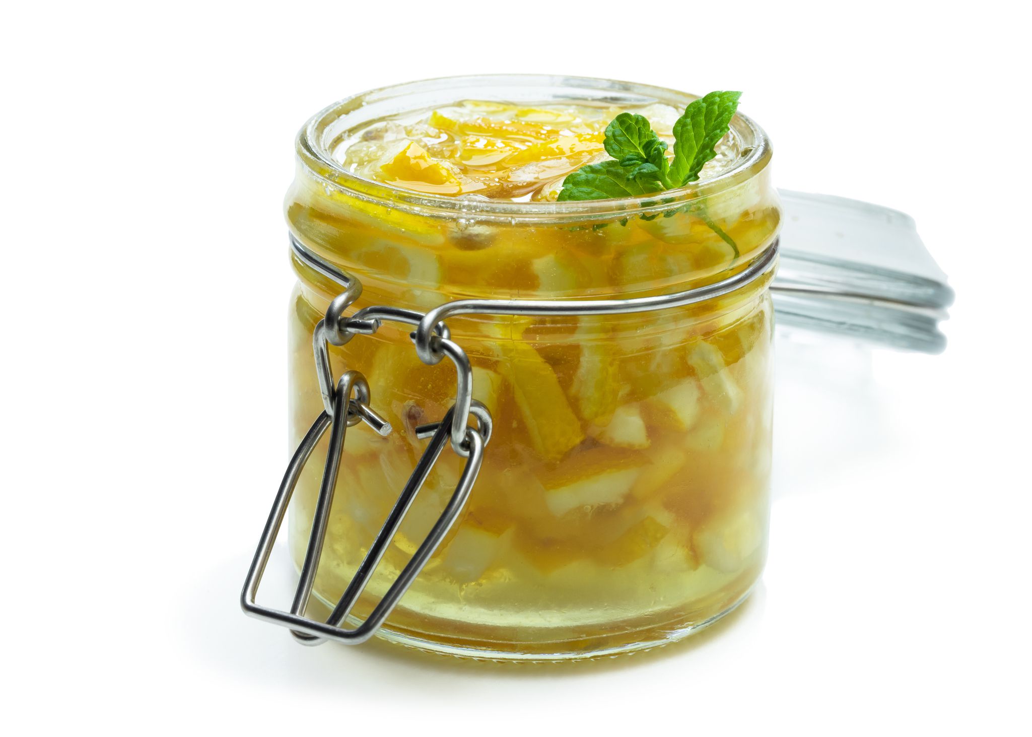 Lemon jam in glass jar isolated on white