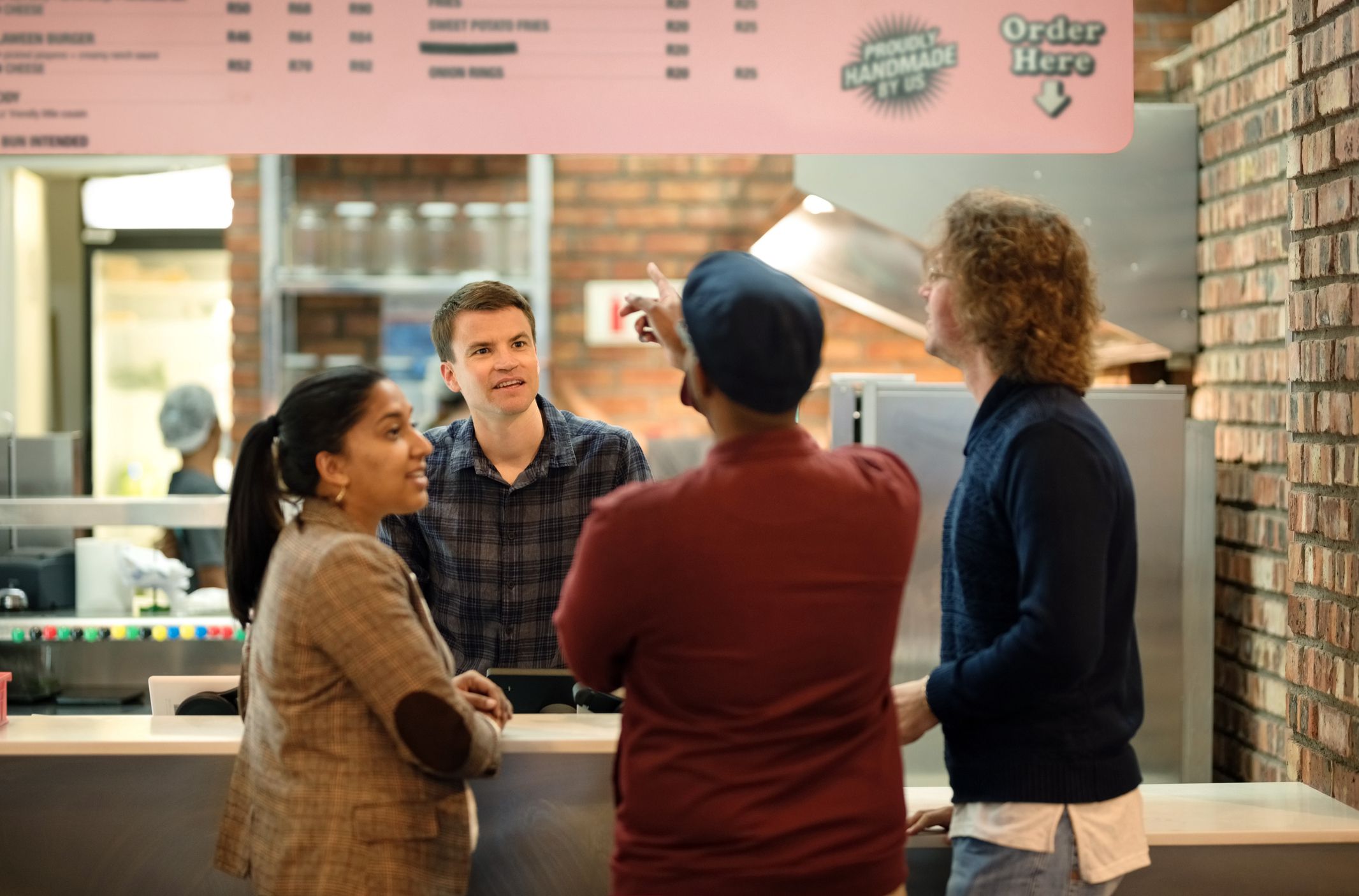 Rear view shot of customers placing their food order at a restaurant