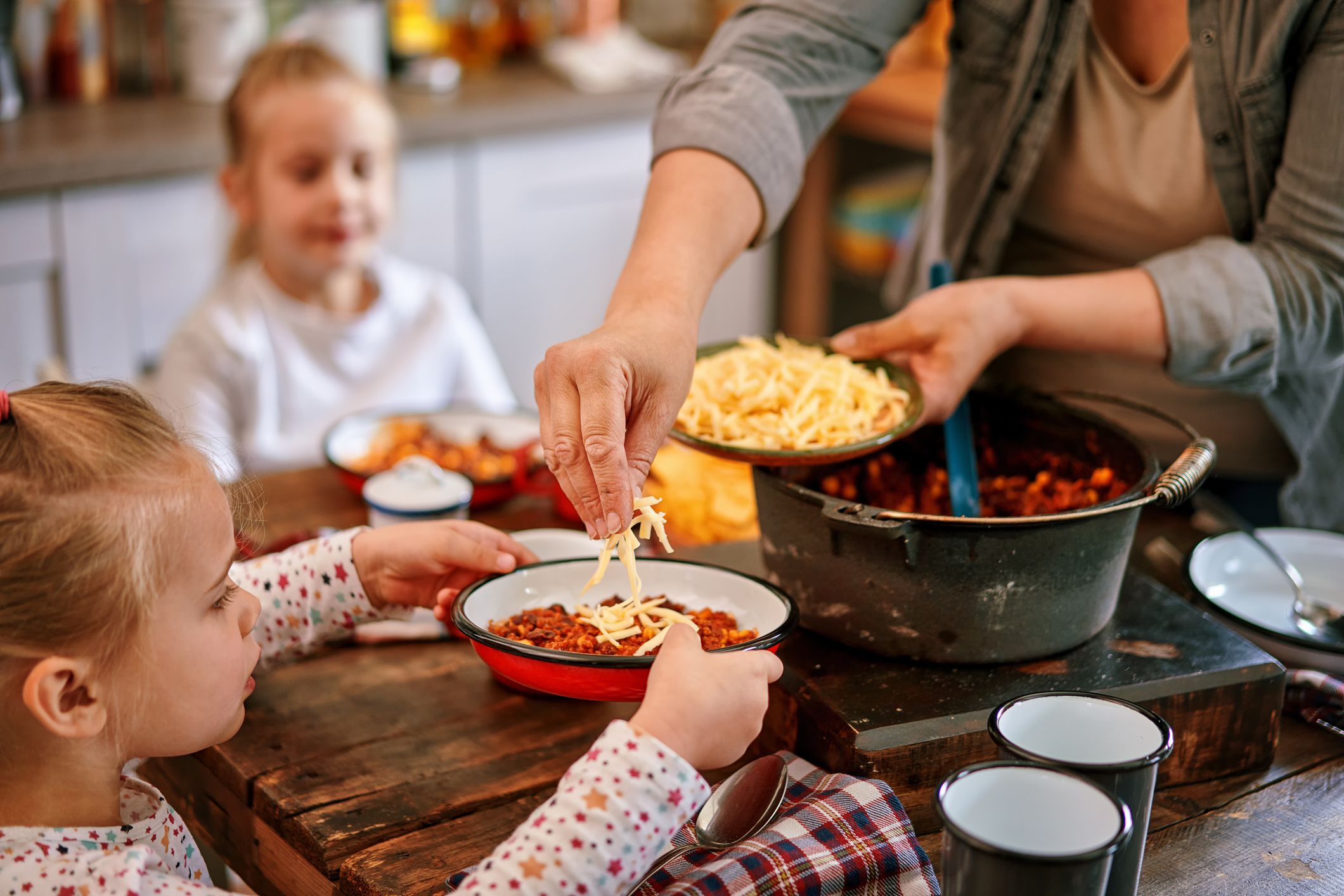 Young Family Eating Chili Con Carne