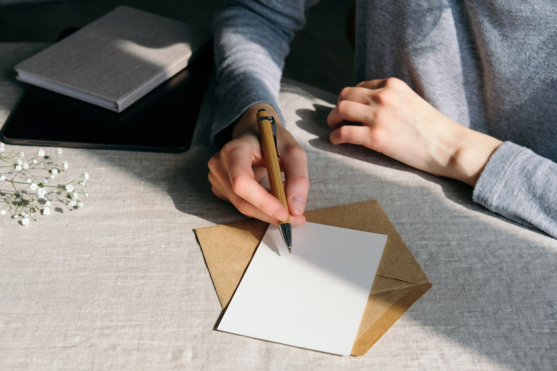 Woman writing romantic letter or wedding invitation card