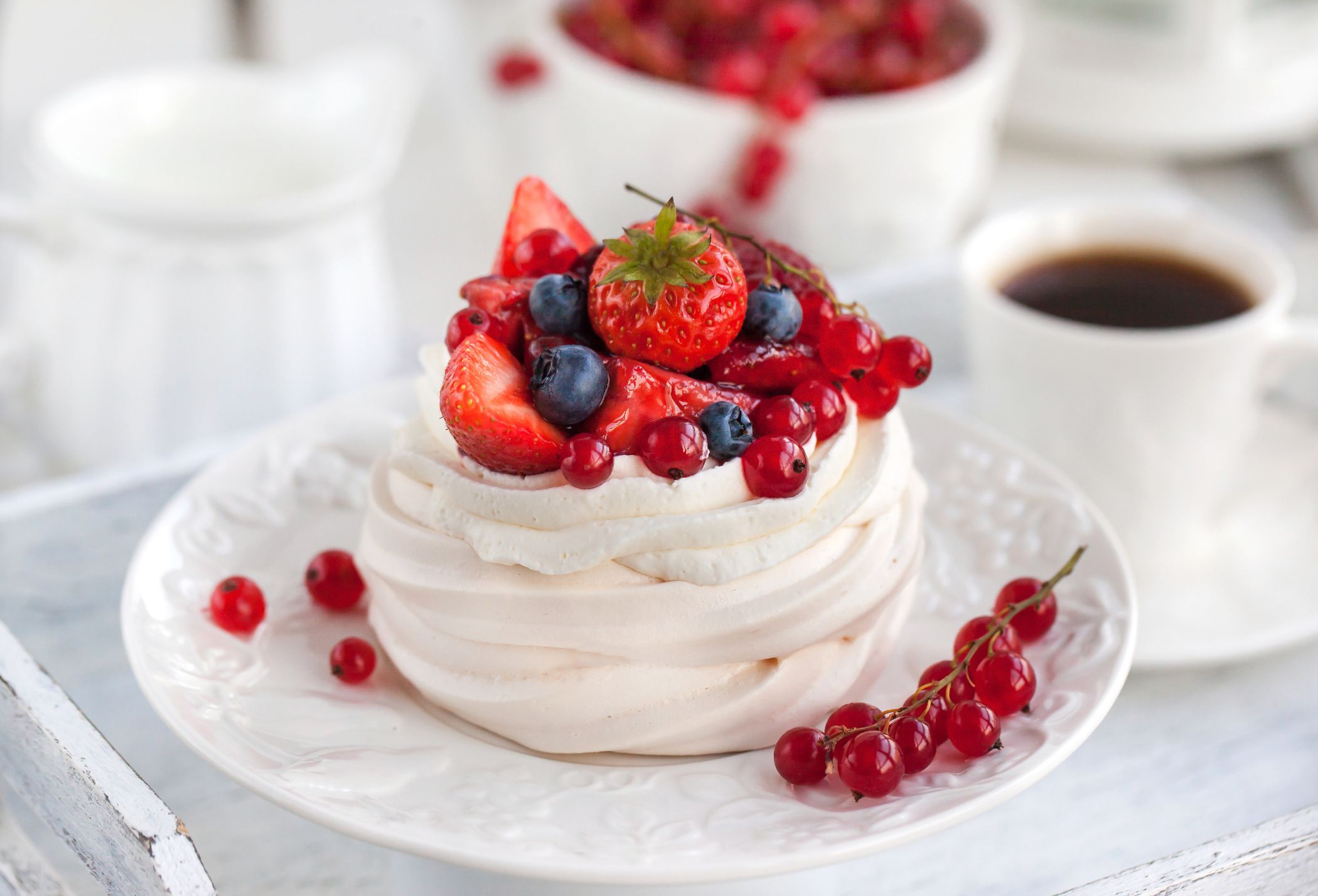 Pavlova meringue cake with fresh berries on white background