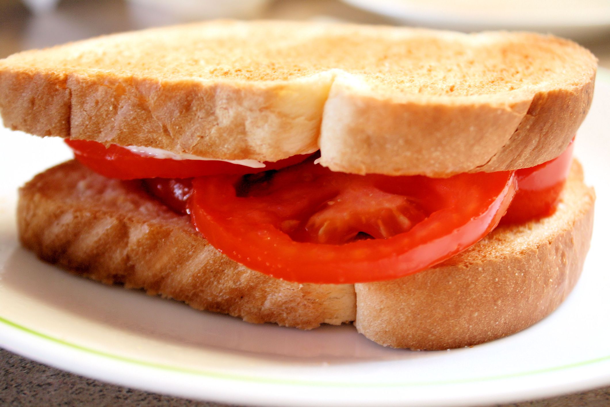 Thick slices of juicy tomato layered between two pieces of toast. Hint of mayo