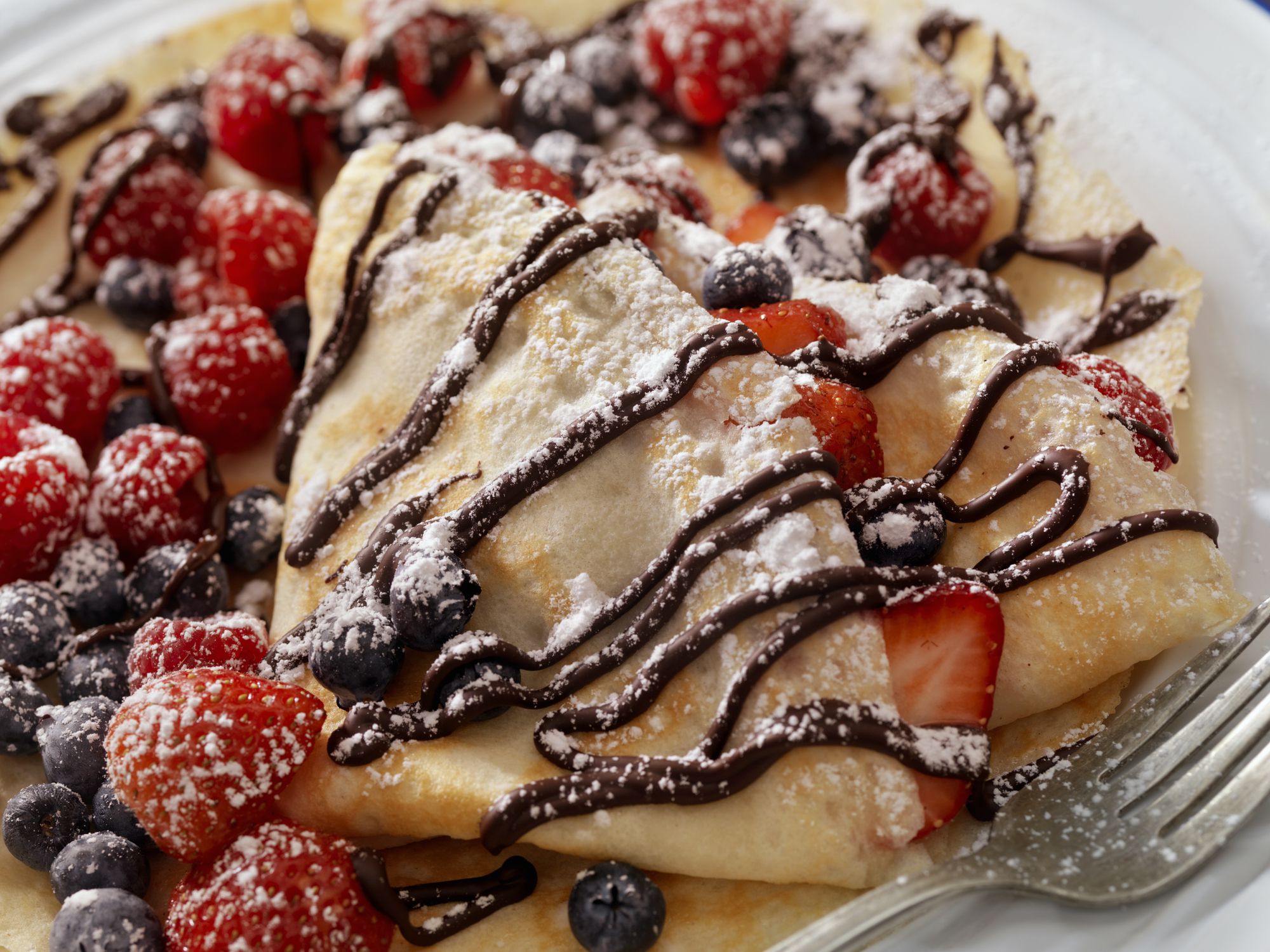 Crepes with Fresh Berries, Chocolate Sauce and Powdered sugar -Photographed on a Hasselblad H3D11-39 megapixel Camera System
