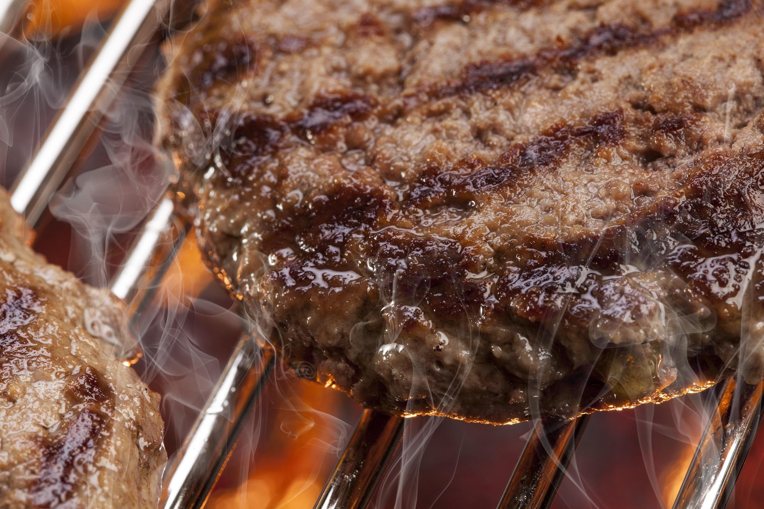 closeup image of beef burger on the grill