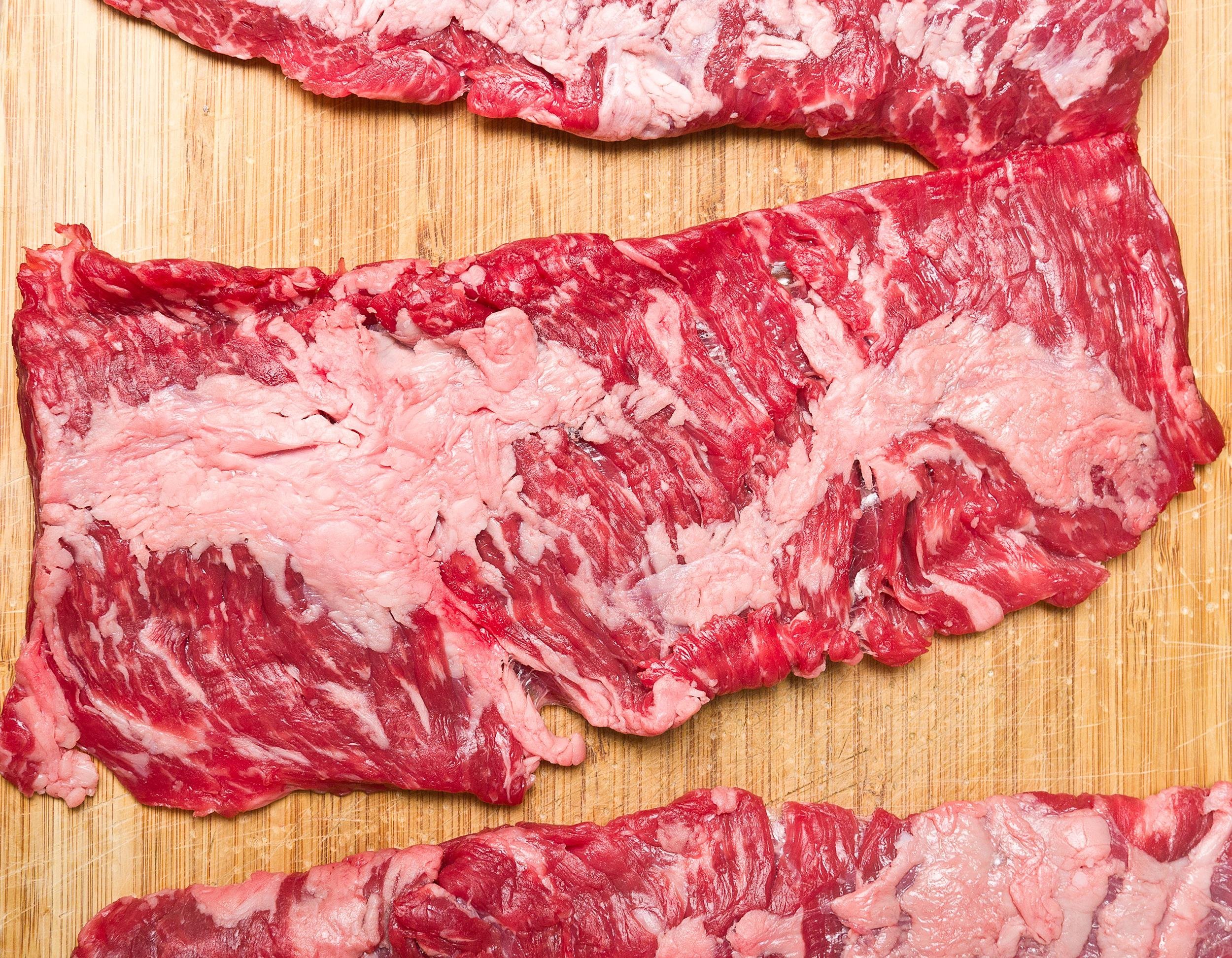 raw skirt steak on cutting board