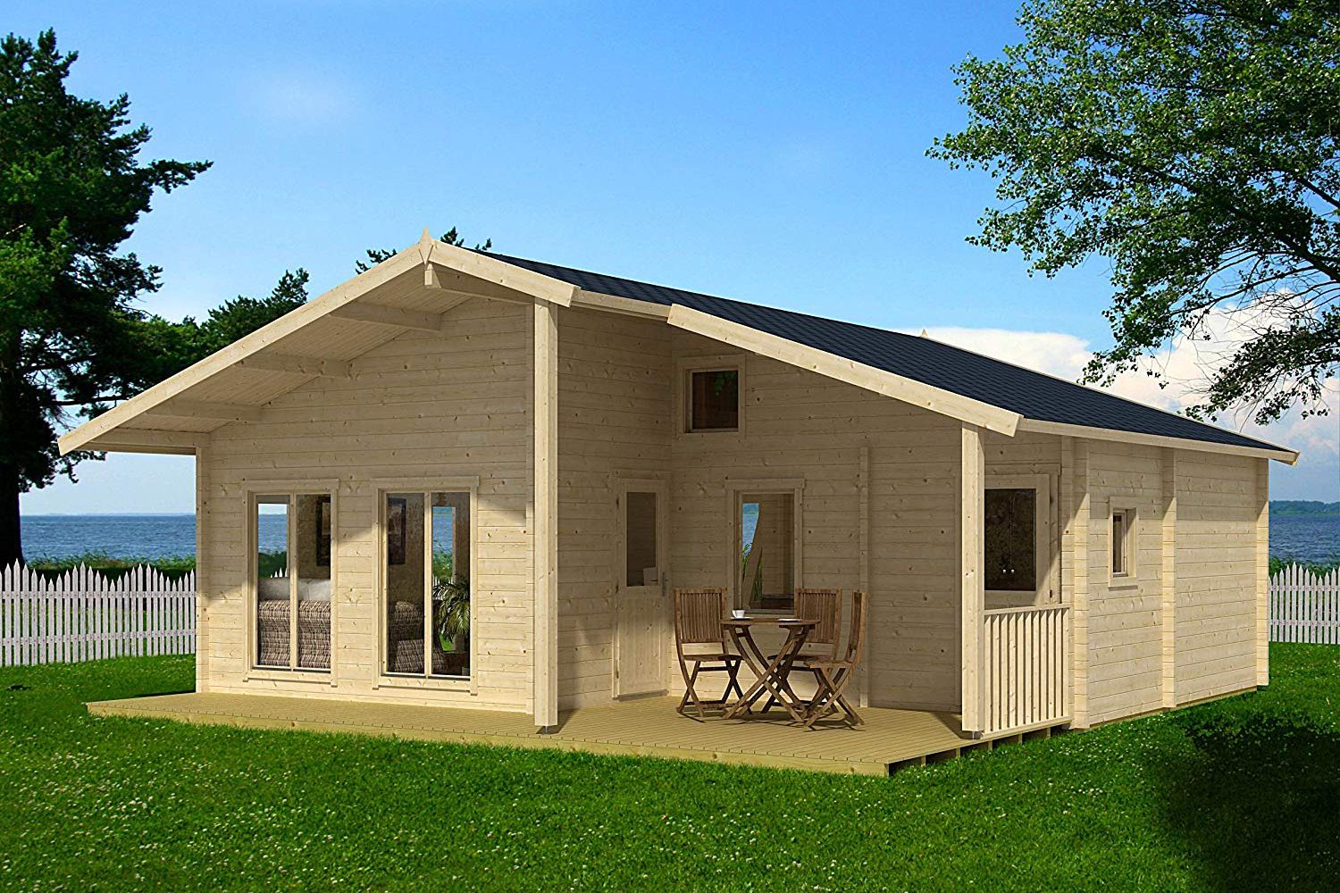 Front exterior of Allwood Avalon, unpainted wood, on a grassy lawn with a white fence and a lake in the background