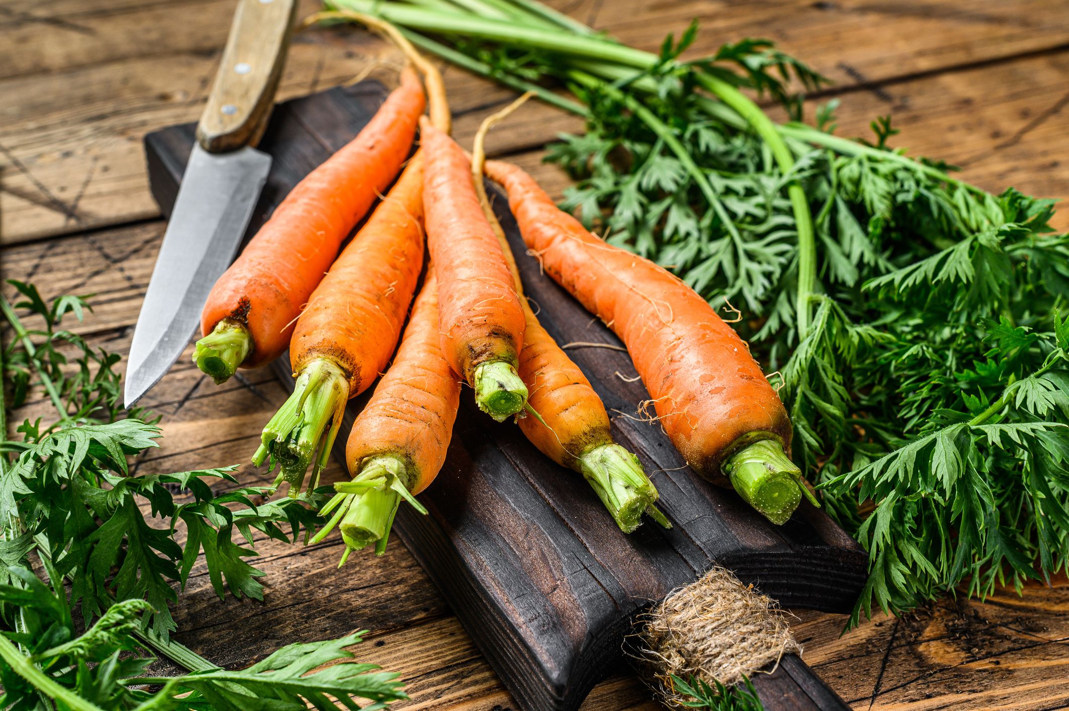A Pile of Fresh Carrots on a Rustic Wooden Table