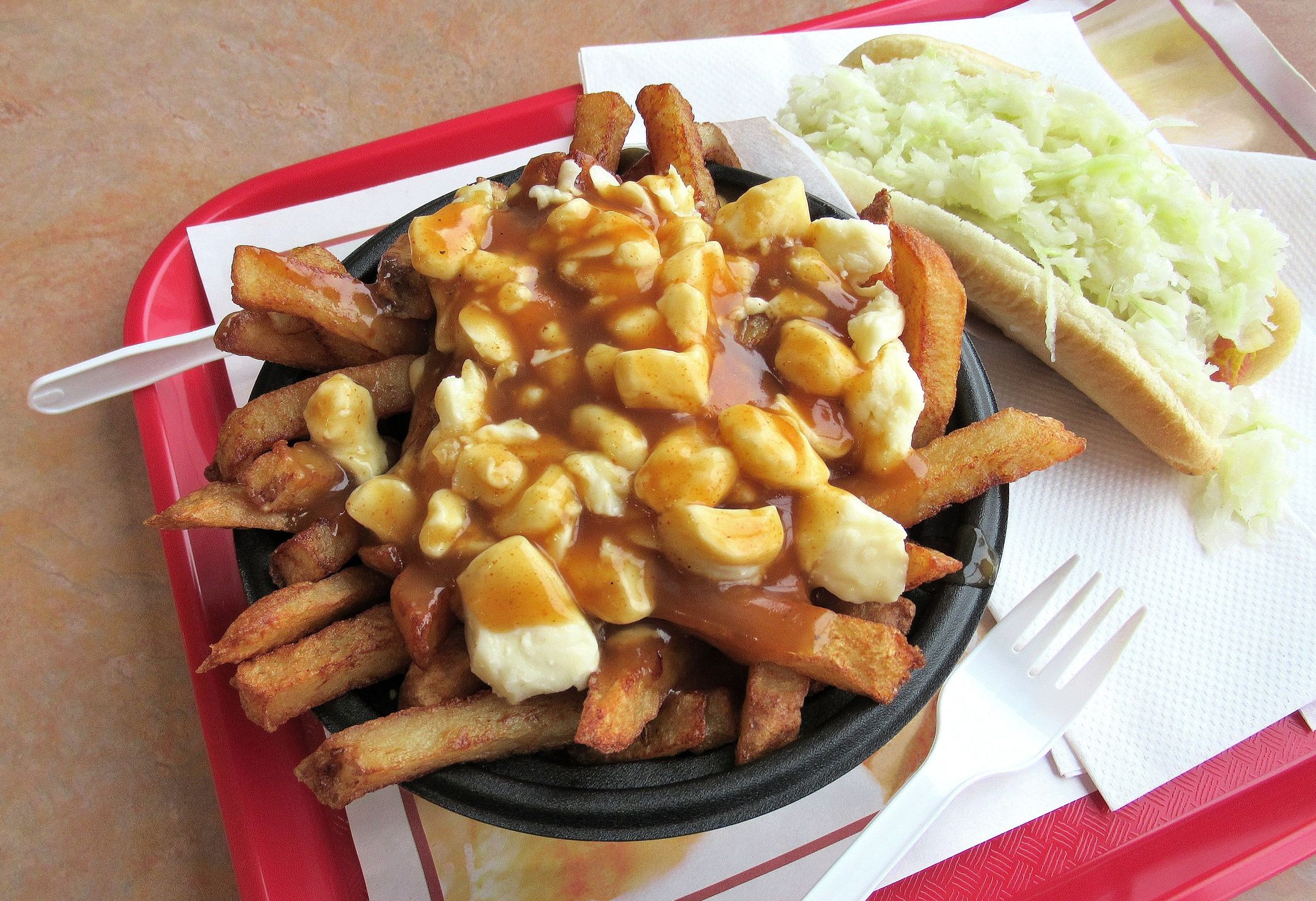 Poutine With Hot Dog on Tray in Restaurant, Montreal