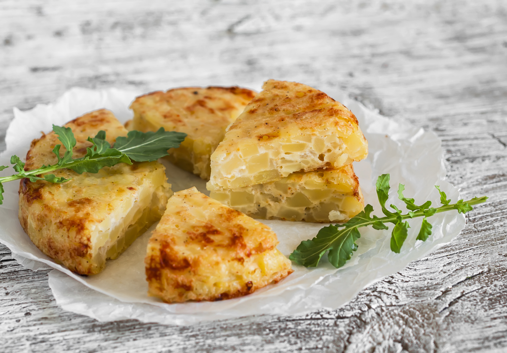 Spanish Tortilla Pieces on White Serving Paper