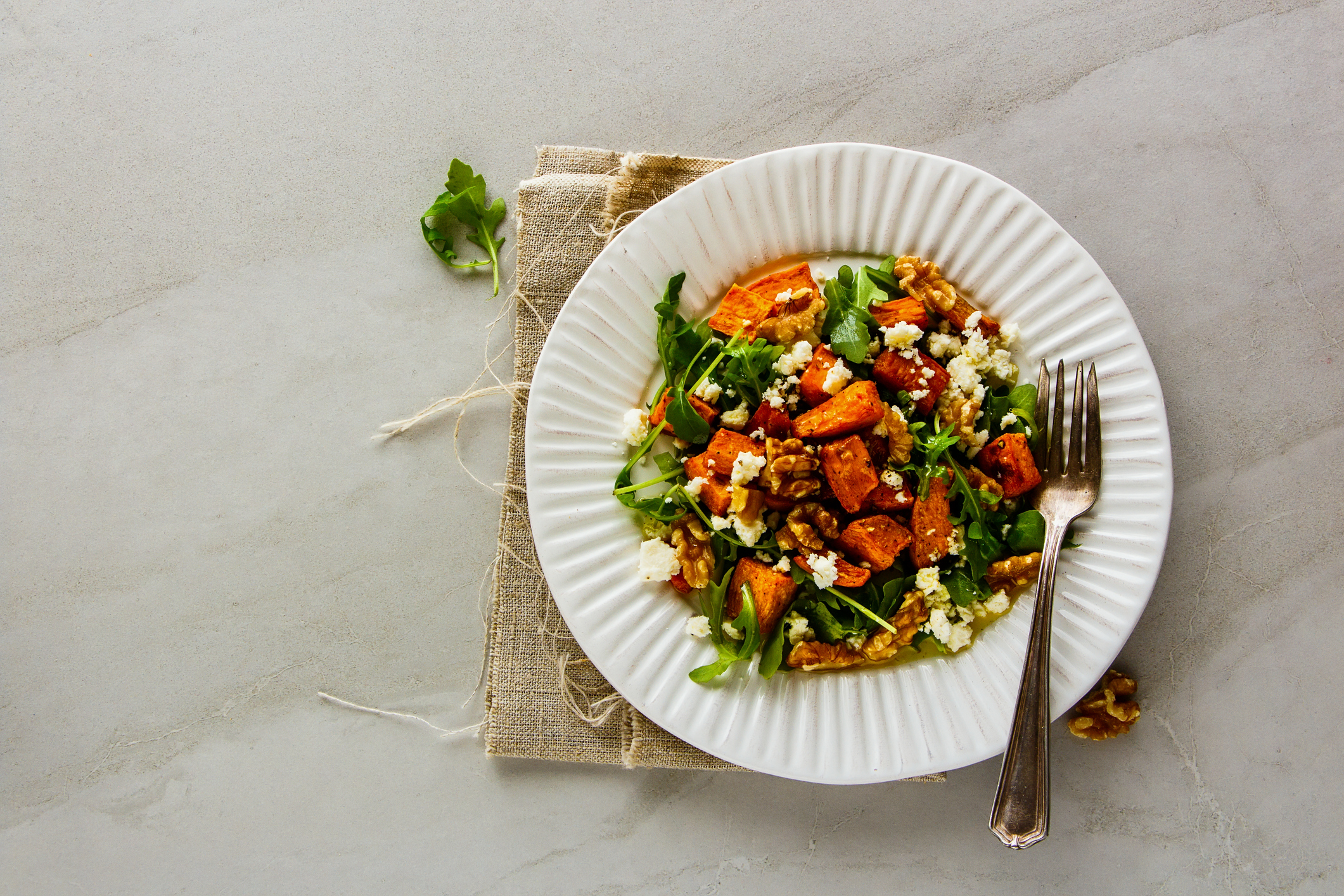 Top-View of Sweet Potato Salad on a Paper Plate With a Fork